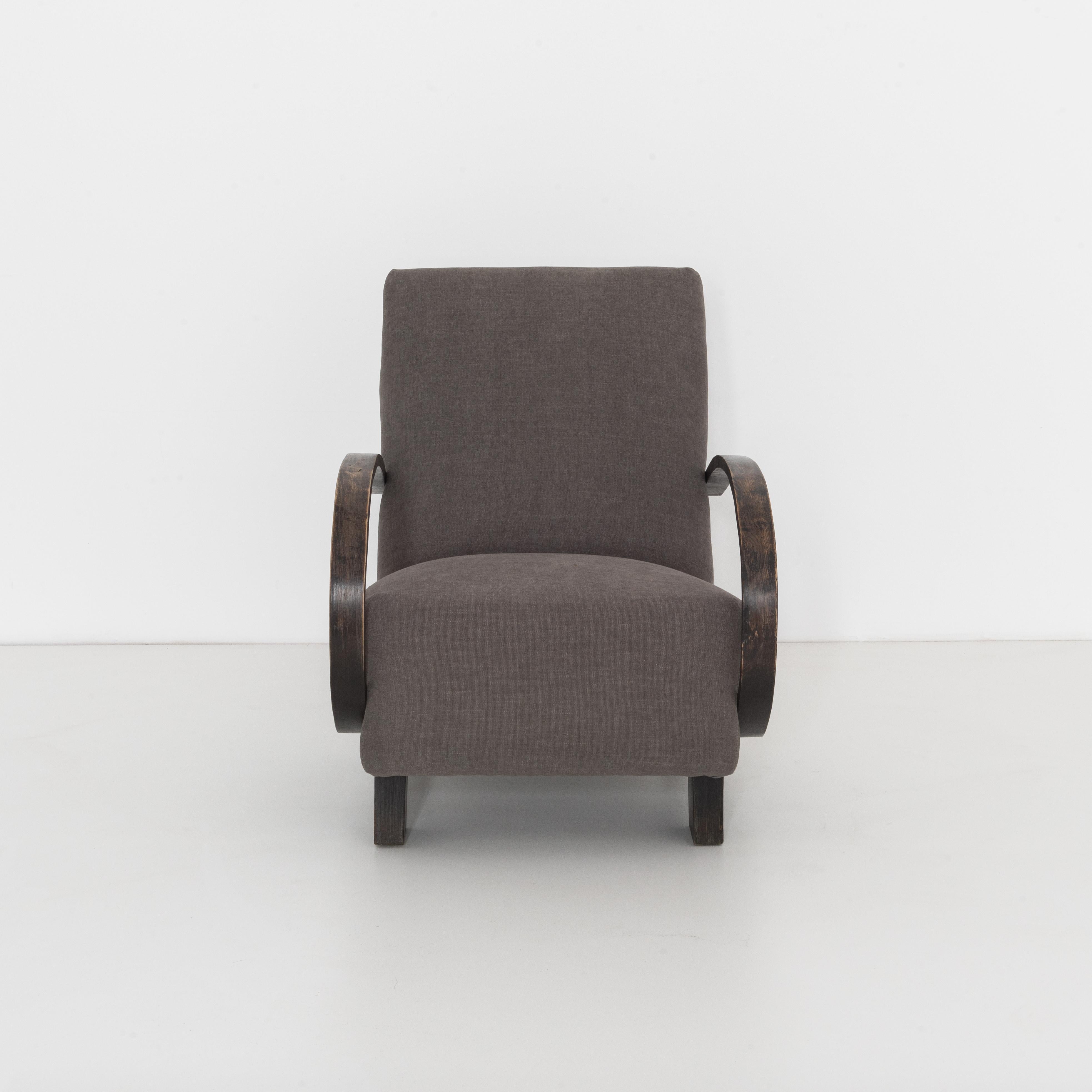 Mid-Century Modern upholstered armchair from Czech Republic, circa 1960. A timeless approach that still looks contemporary and fresh. In the style of Jindřich Halabala with bent beech armrests and geometric legs, re-upholstered with a grey