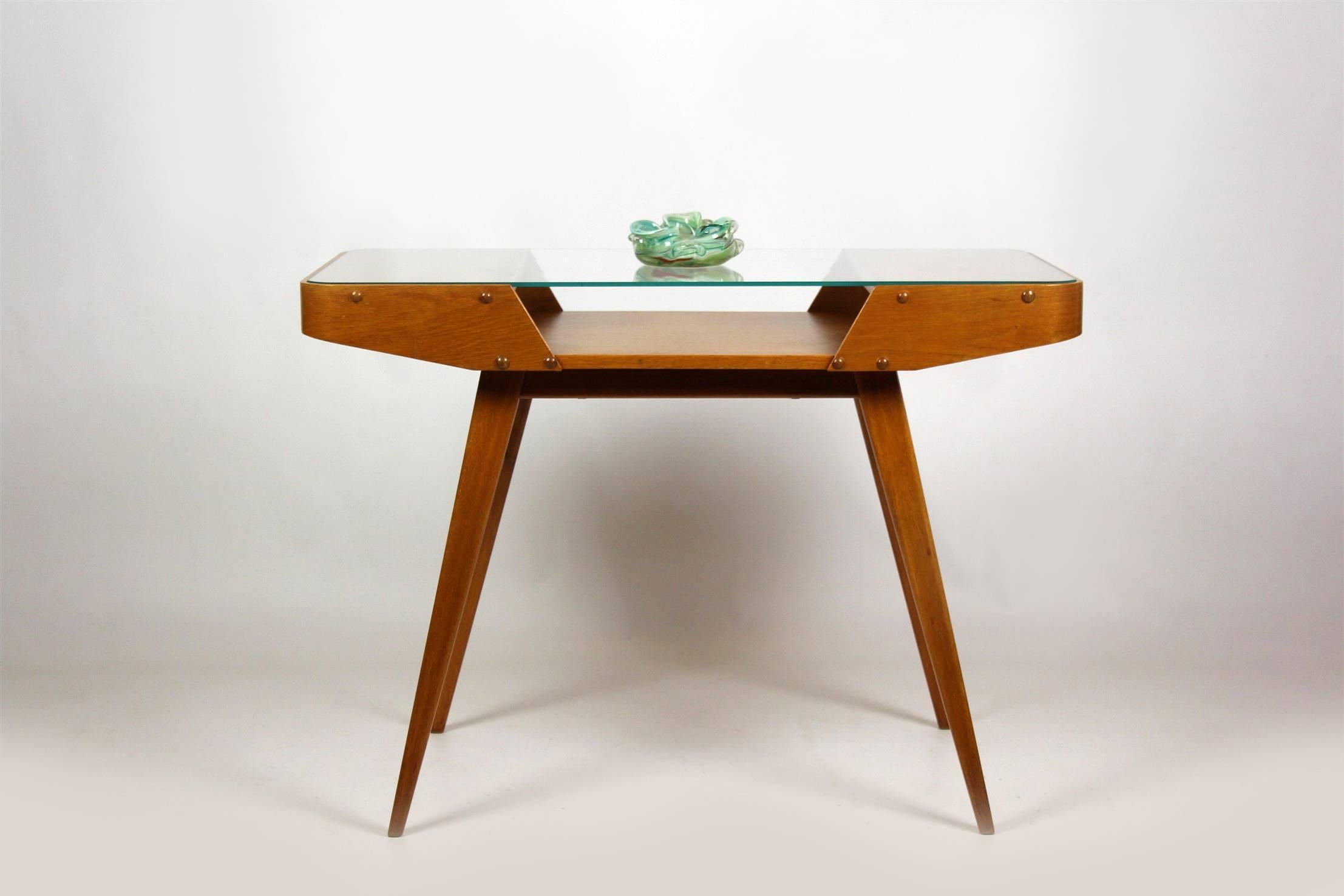 This coffee table was made in the 1960s by Západoslovenské Nábytkové Závody in former Czechoslovakia. It features satin-lacquered woodwork and the glass top is in original condition.