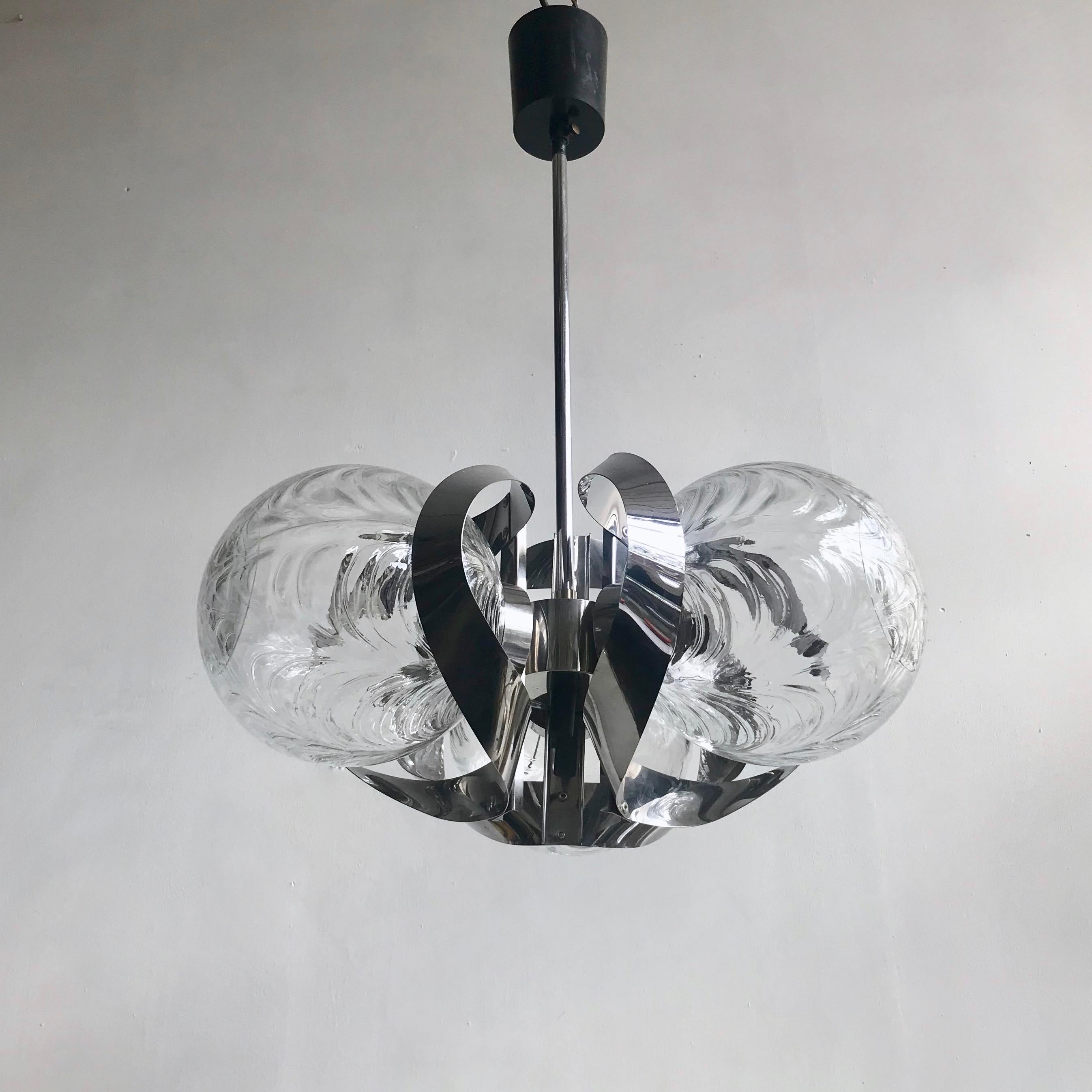 Midcentury Czech pendant with chrome base and 3 clear textured globe glass shades. The pendant is suspended on a central rod leading to 3 lamp brackets. The shade of these brackets mirrors the swirls in the glass shades.
 