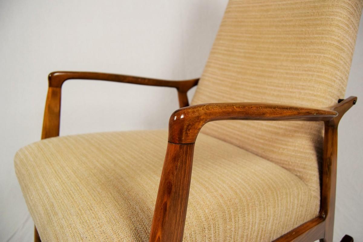 This rocking chair is in very good original condition. Fabric upholstery has some minor signs of use. Wood was repolished.