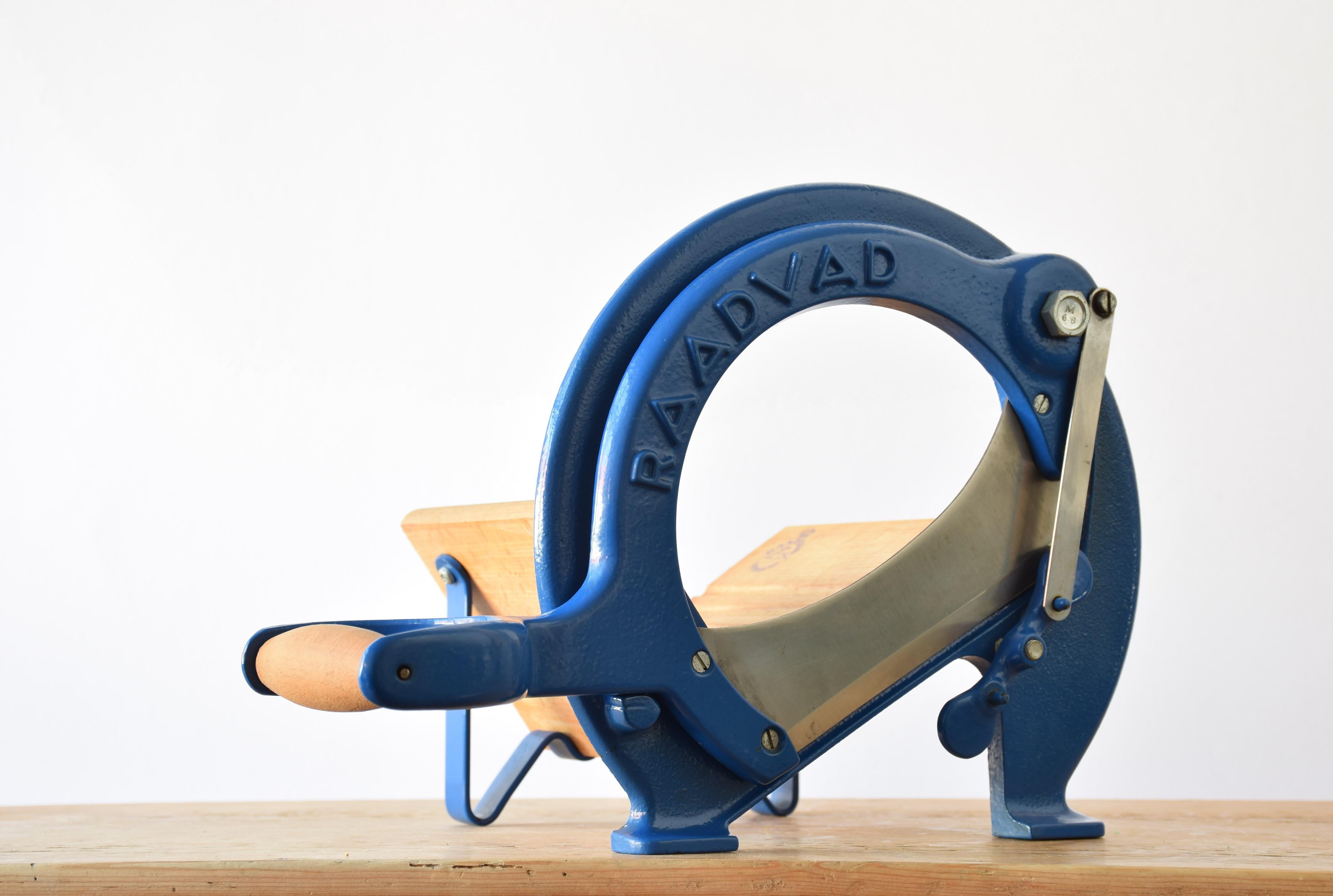 This iconic Danish bread slicer was produced by Raadvad in Denmark, circa 1970s-1980s. It comes with original lacquer in the more rare blue version. The bread slicer is fully functional for slicing bread, especially black bread and firm bread and is