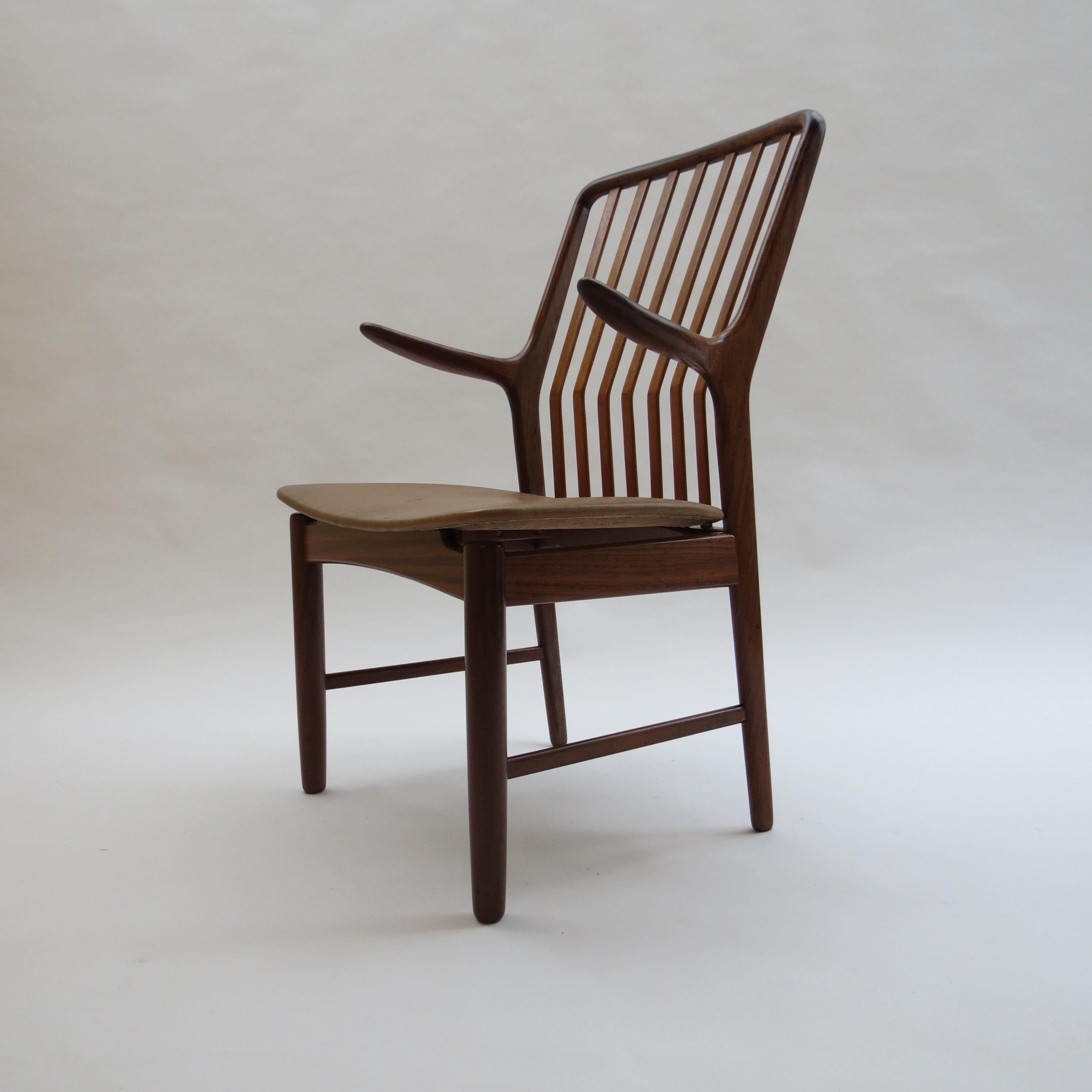 Midcentury Danish chair by Svend Madsen from the 1960s. Teak frame and newly reupholstered seat in vintage brown leather.

Designed by Svend Madsen Denmark.

In good condition, the seat has recently been reupholstered with vintage leather.