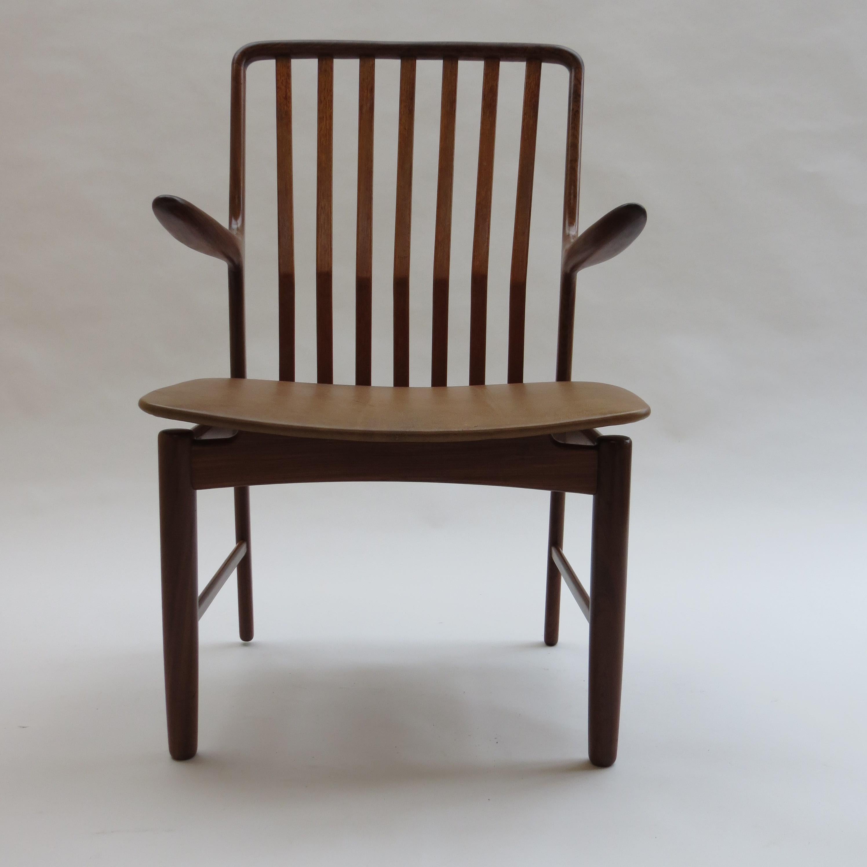 Danish chair in solid Afrormosia with solid teak slats, and newly reupholstered in vintage brown leather seat.

Designed by Svend Madsen, Denmark.

In good condition, the seat has recently been reupholstered with vintage leather. Stunning