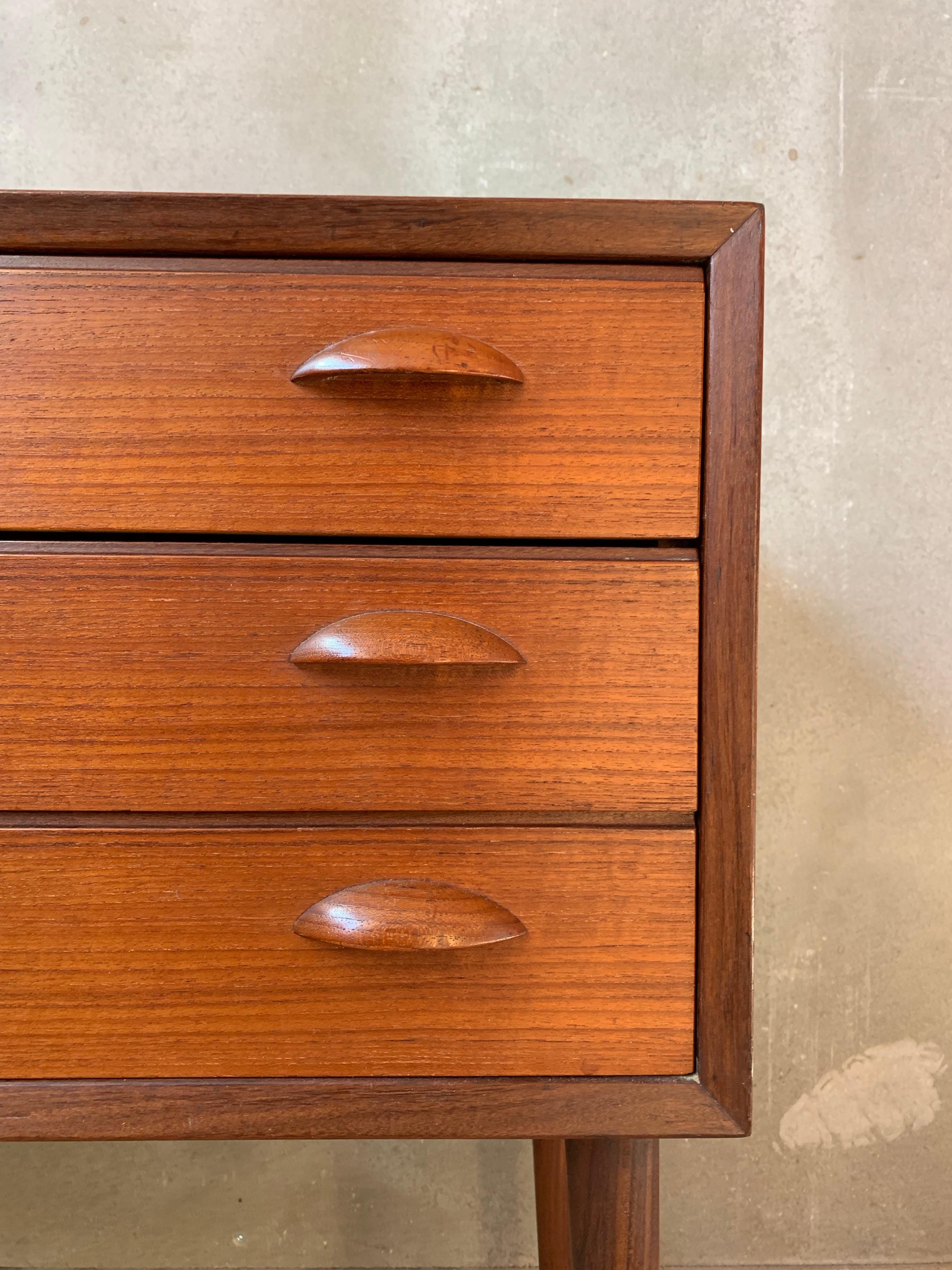 Small chest of drawers made of teak featuring three drawers and tapered legs, manufactured in Denmark, 1960s.