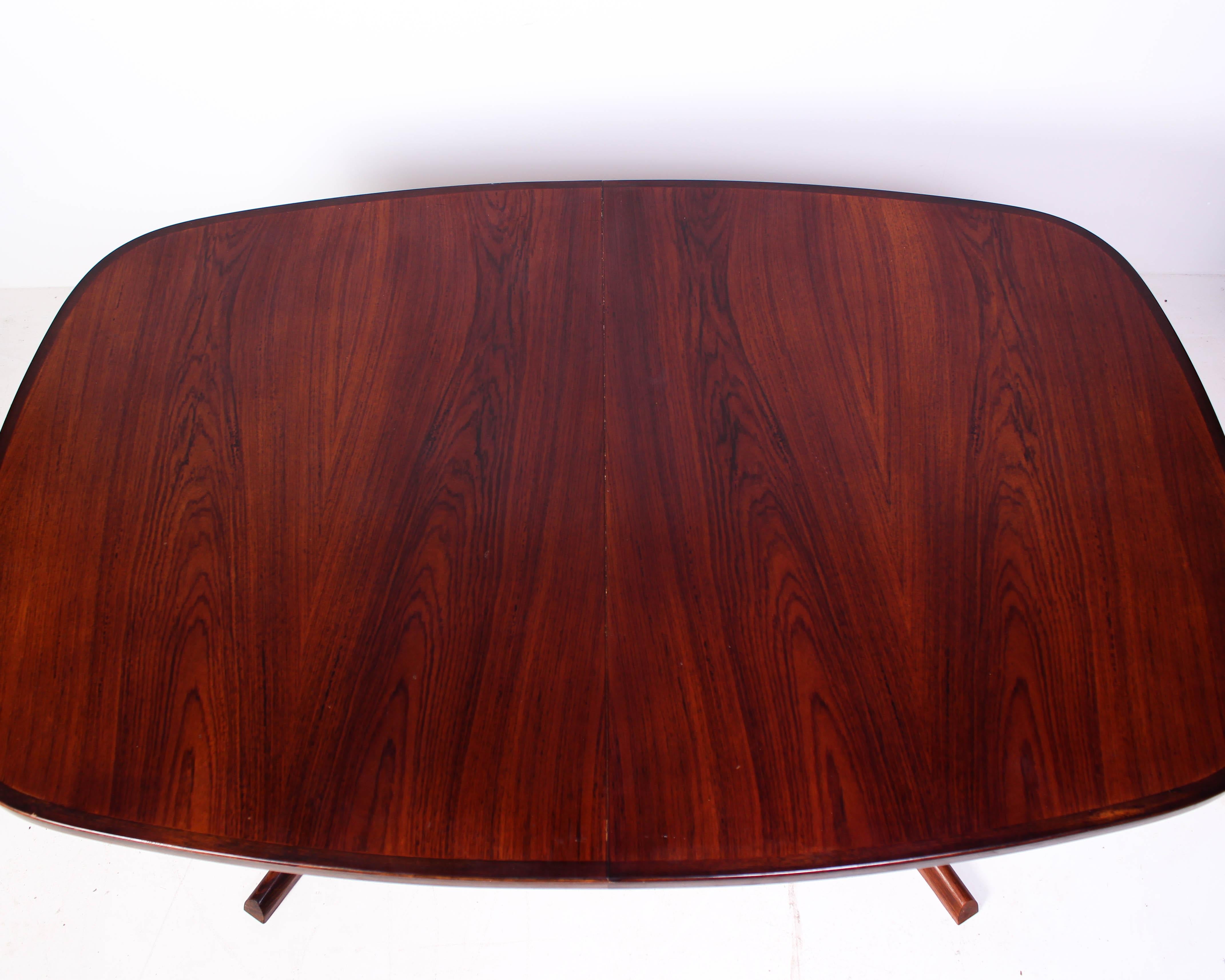 Midcentury rosewood dining table attributed to Danish designer Niels Otto Møller and produced by Gudme Möbelfabrik. The table is in good vintage condition with signs of usage consistent with age and use (especially on the edges of the table where