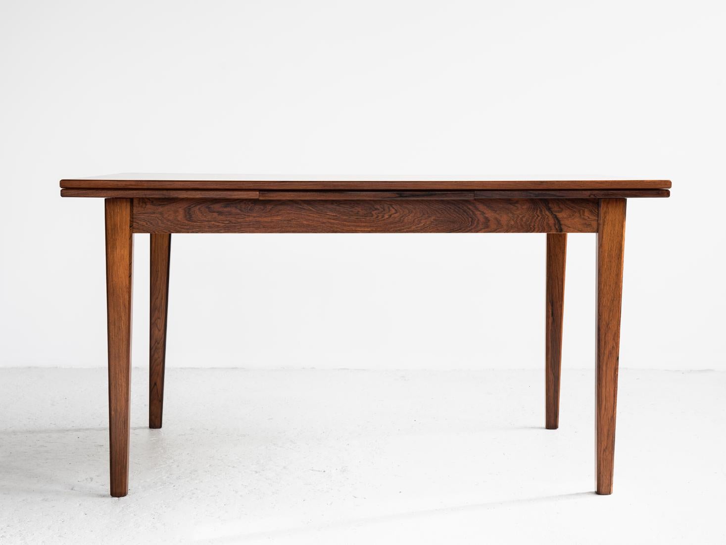 Midcentury table made in Denmark in the 1960s. The dining table is easily extendable on either one or both sides. It has beautiful drawings in the wood. The table is made of rosewood and in very good condition.

Dimensions:
Height 74 cm
Length
