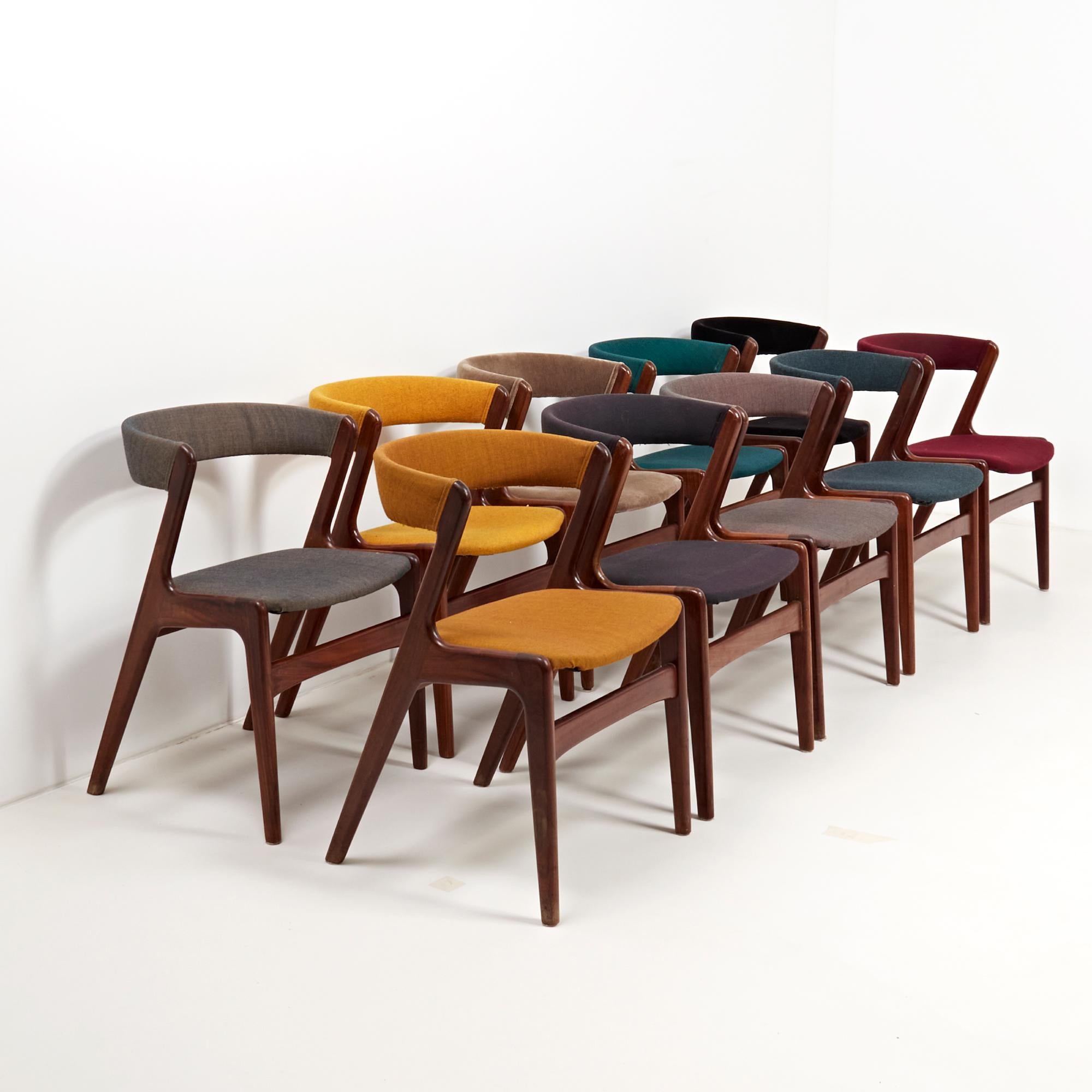 Exemplifying Mid-Century Modern design, this set of ten T21 fire chairs designed by Korup combine sleek curves with angular lines to create an iconic silhouette.

Constructed with solid teak wood bases, the chairs have curved backrests and are