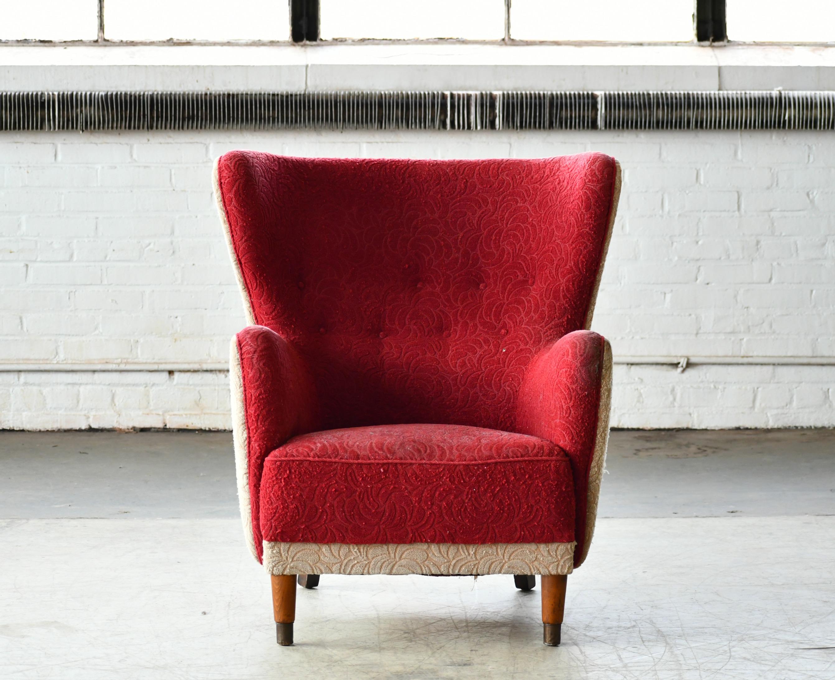 Unique Danish lounge or club chair in the style of Fritz Hansen's and likely made circa 1950. Superbly comfortable with dramatic angled design and generous proportions and a charming and very strong presence to anchor any room. We are able to
