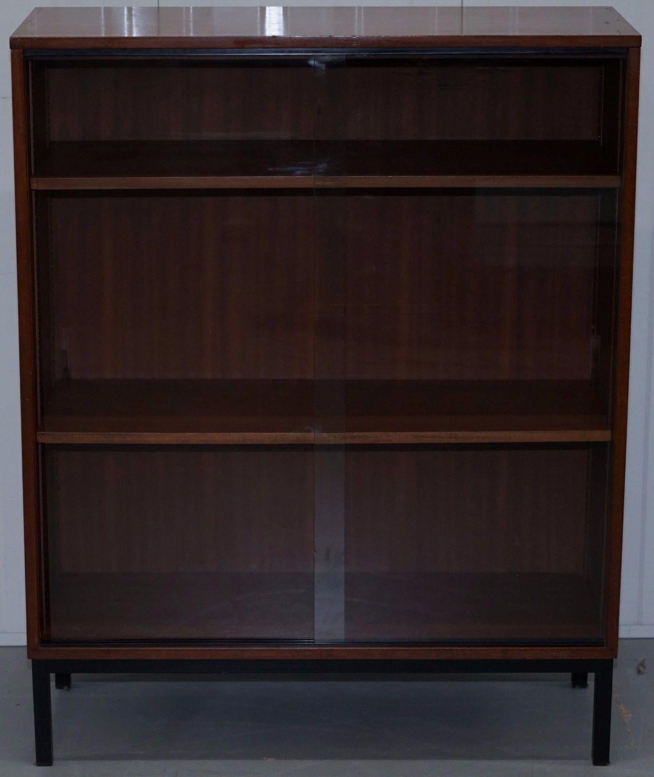 We are delighted to offer for sale this absolutely stunning Danish mid-century mahogany veneer glass doored display cabinet

A really on trend and stylish piece that’s extremely functional, the glass doors slide revealing height adjustable