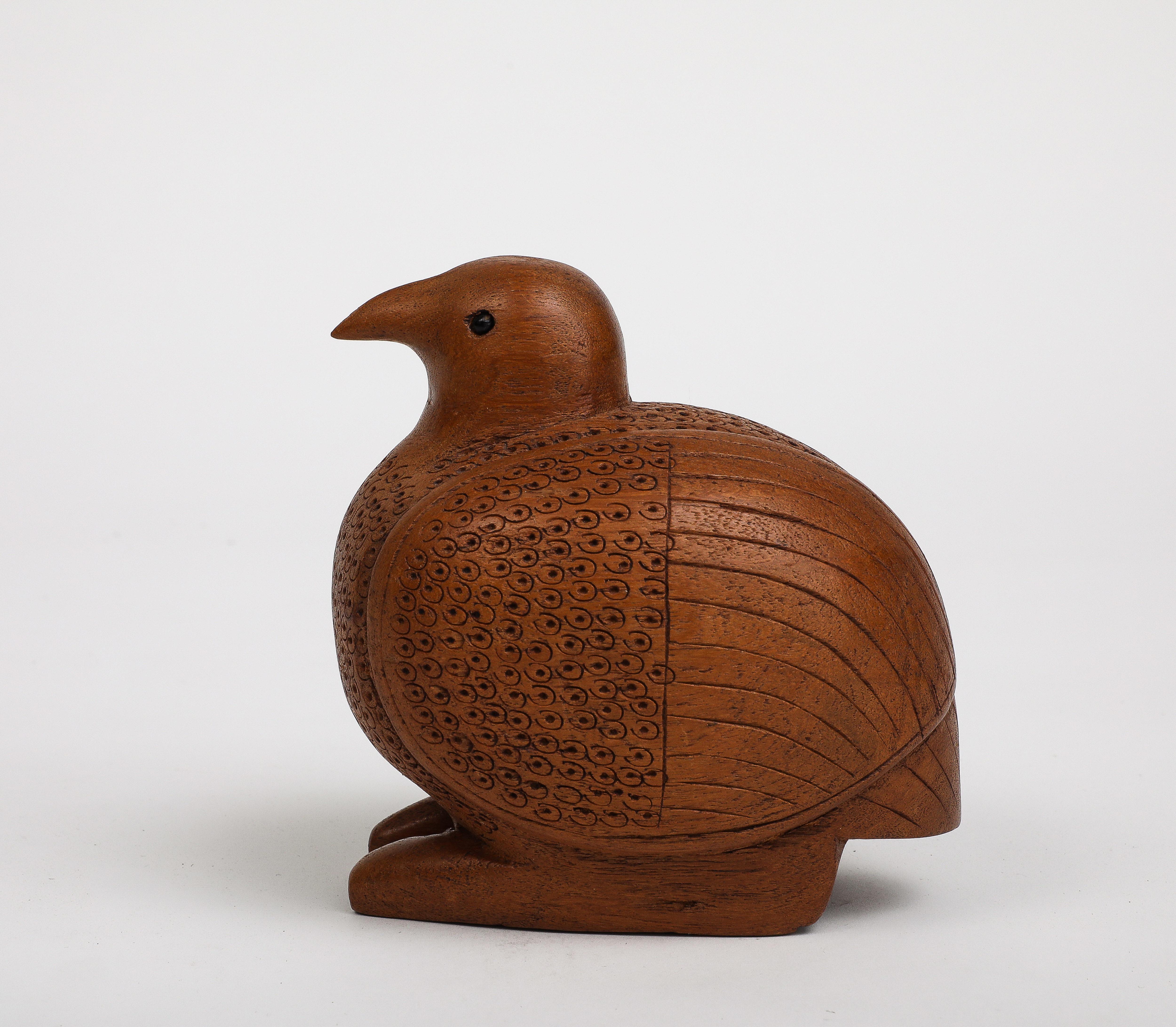 Midcentury Danish hand-carved wooden bird, circa 1950. Rounded body shape with feather-like carvings on the breast and wings. Black bead eyes. 