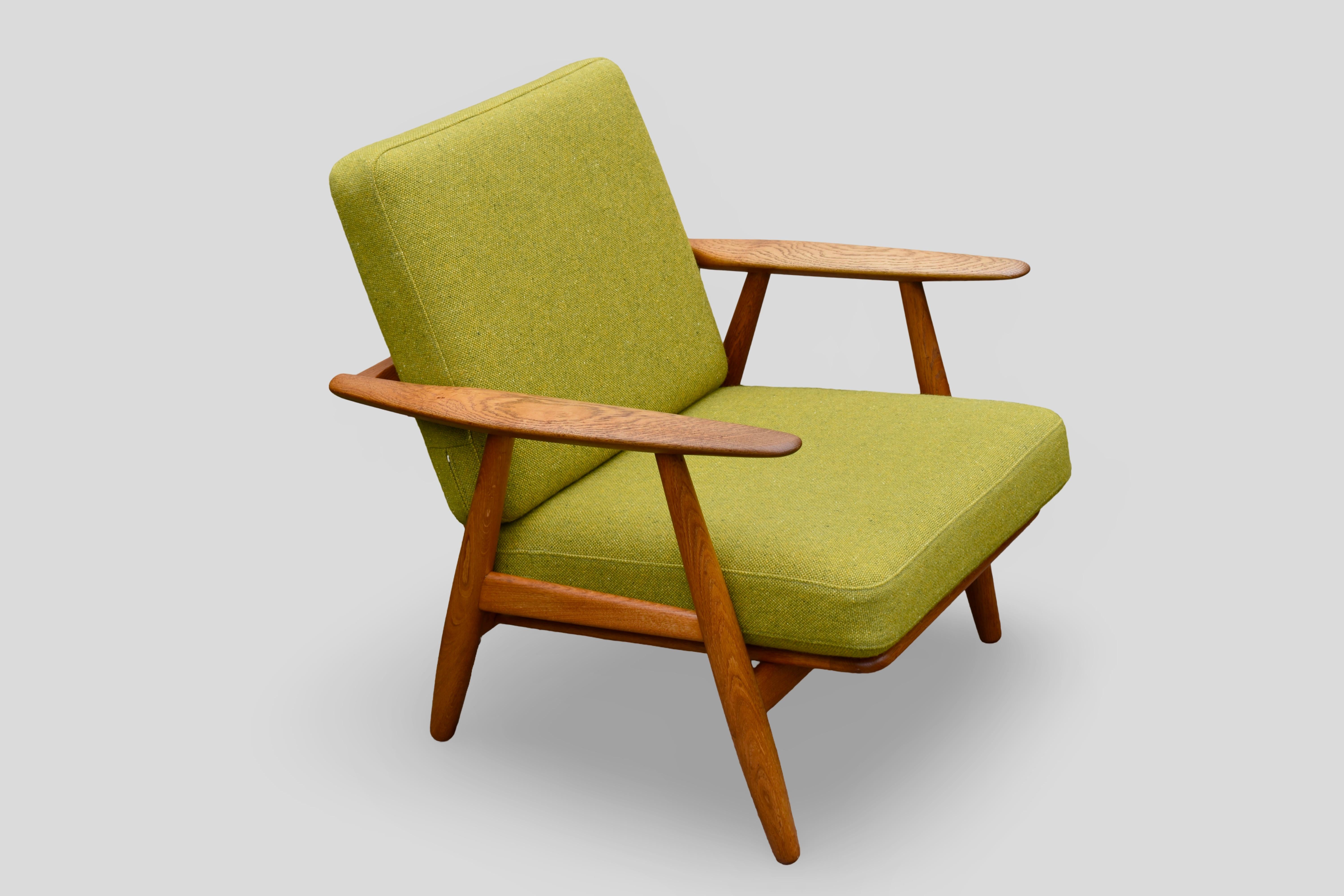 Classic design from 1954 by the master of Danish Modern, Hans Wegner.

Solid Oak frame with original sprung cushions upholstered in a high quality tweed wool very sympathetic to the fabrics originally used in the 50’s.

A particularly nice example