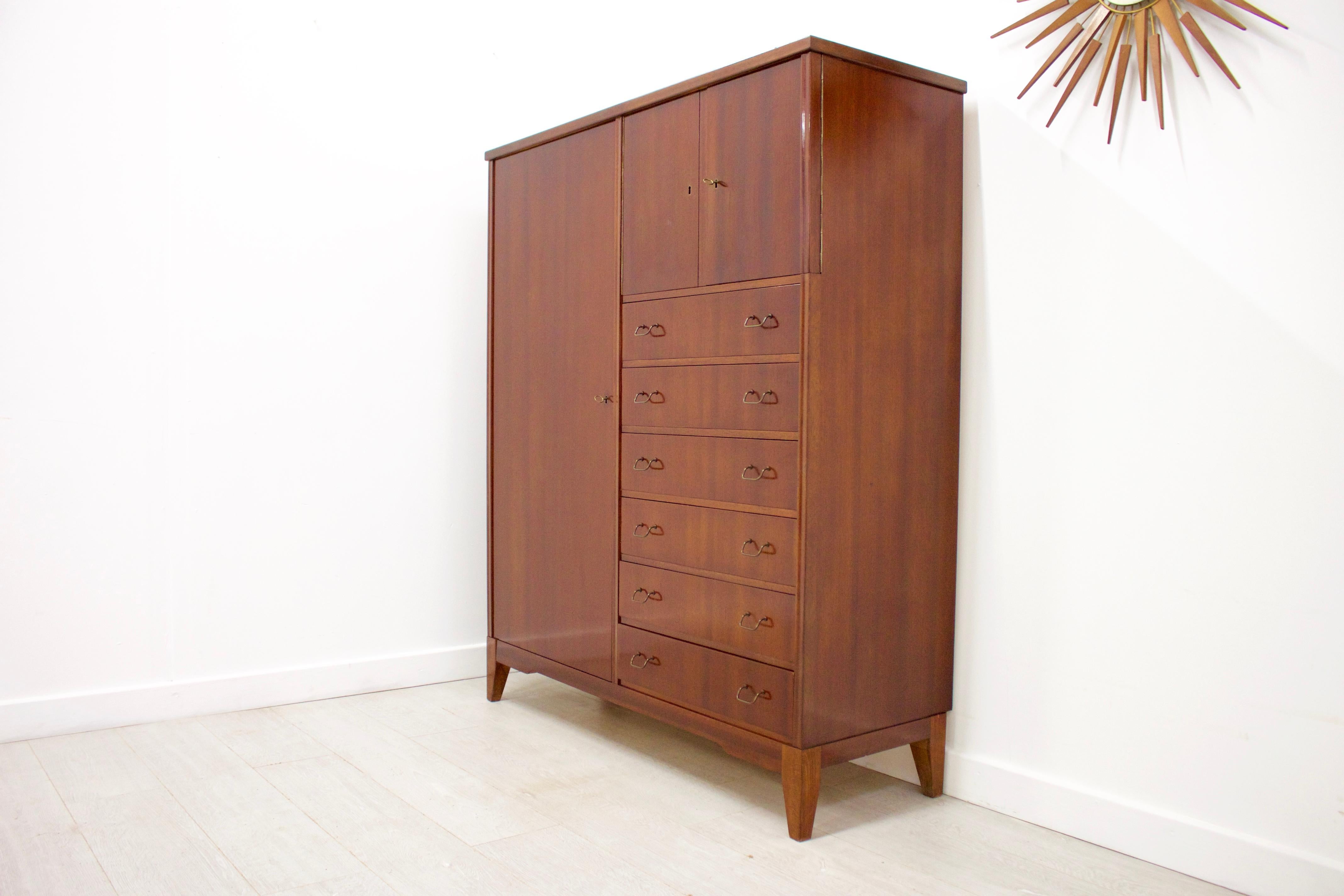 - Mid-Century Modern linen cabinet / cupboard or tallboy
- Made in Denmark
- Made from solid wood and veneer.