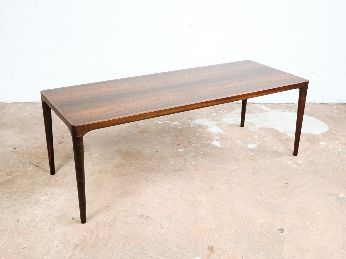 Midcentury coffee table made in Denmark in the 1960s. The coffee table has nice drawings in the wood. It has a refined design and can fit in any interior. It is made of rosewood and is in very good condition.