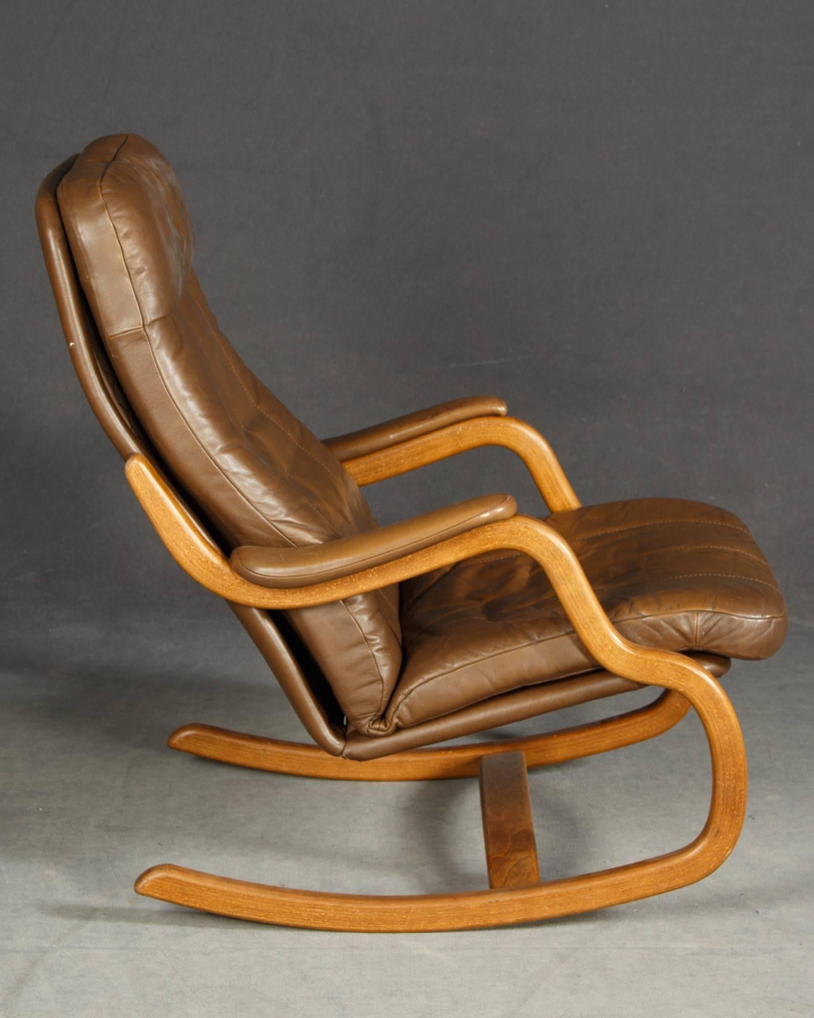 Midcentury Danish lounge chair with ottoman and leather cushions. Nicely executed design.