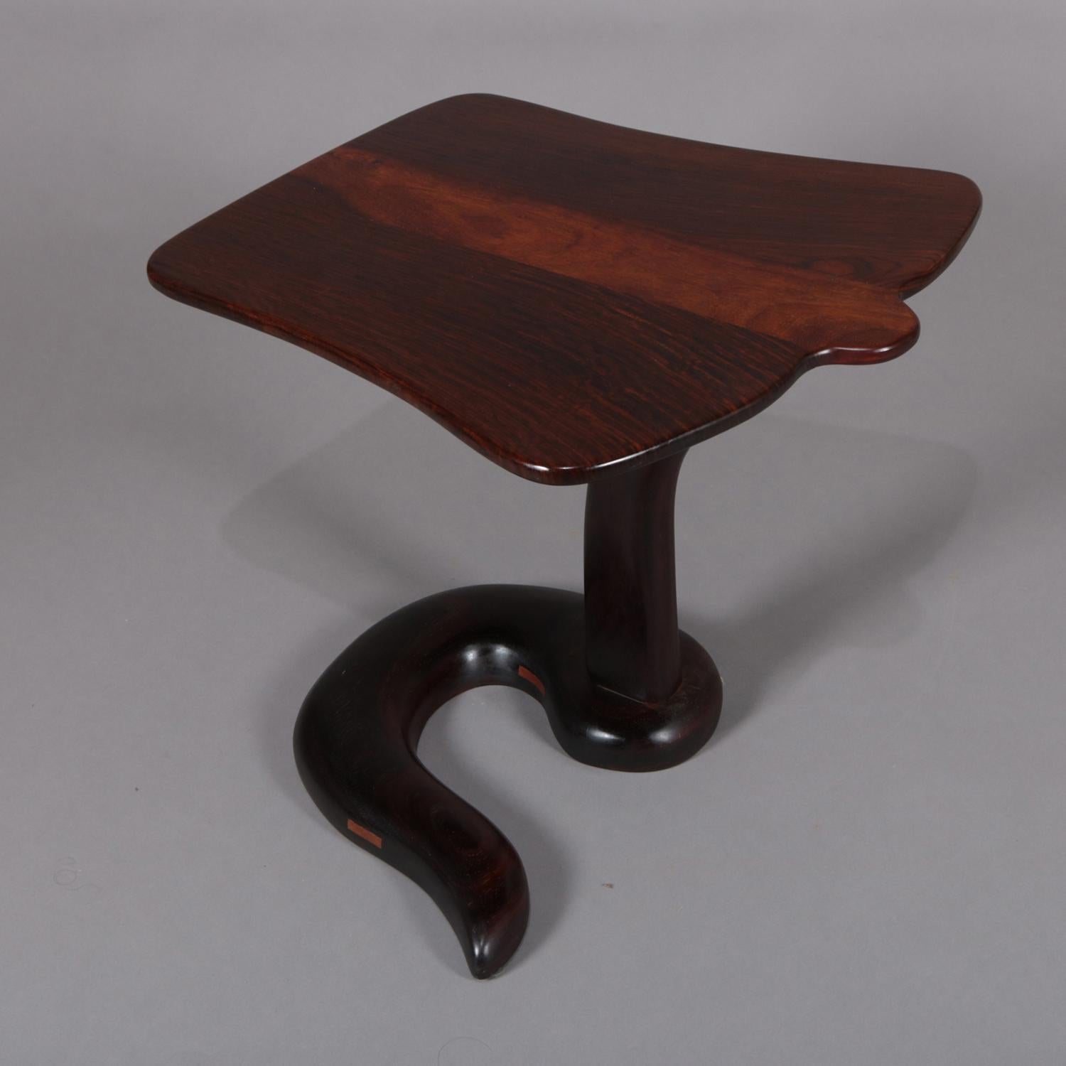 A midcentury Danish modern custom cobra side stand features rosewood construction with shaped two-tone display supported by carved winding snake form base, 20th century.

Measures: 20