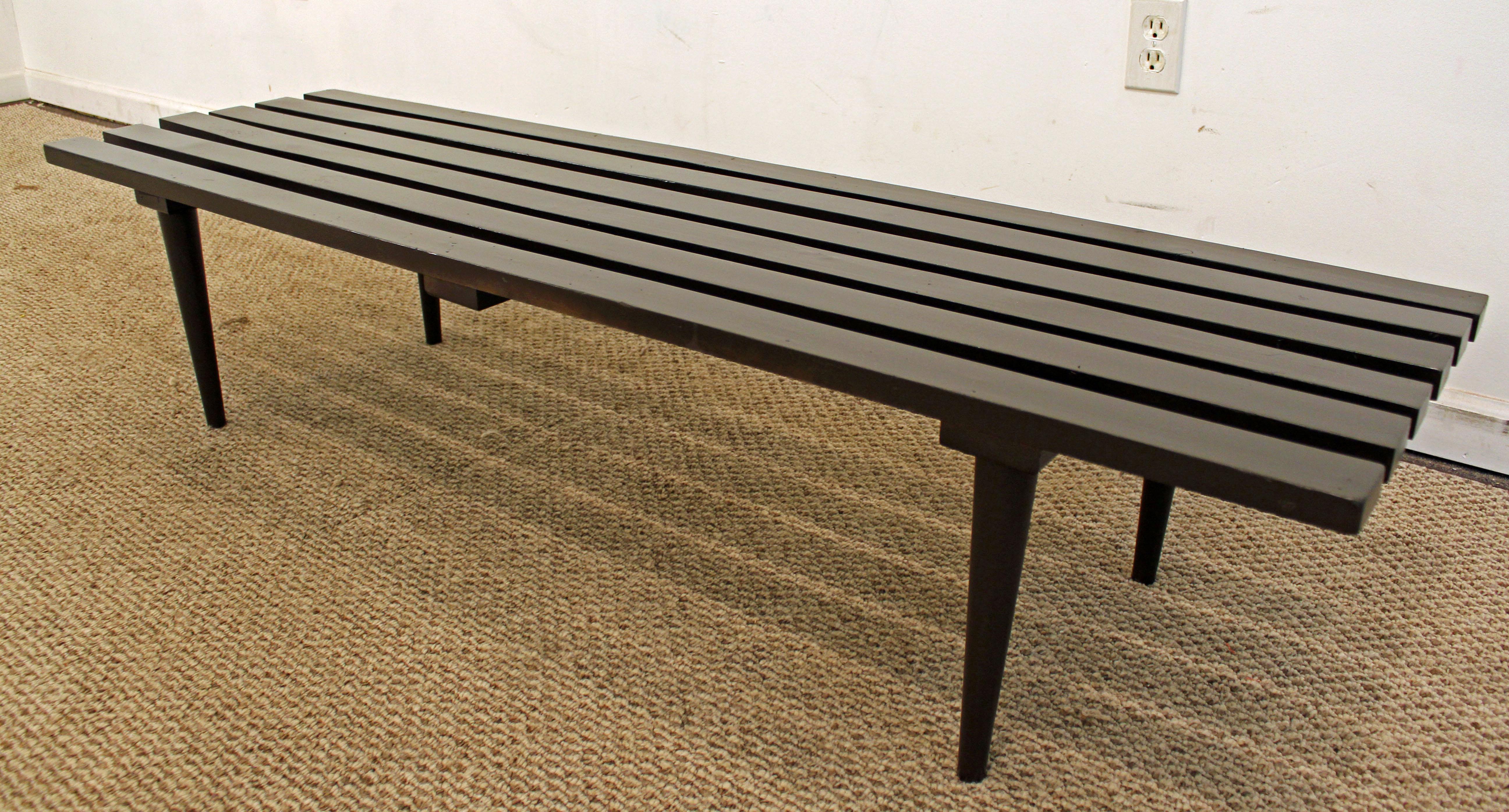 What a find. Offered is a midcentury slat bench coffee table. This piece has been ebonized or painted black. Is in great condition considering its age. This is the one that will add to any room in your home. It is not signed. 

Dimensions: 
60