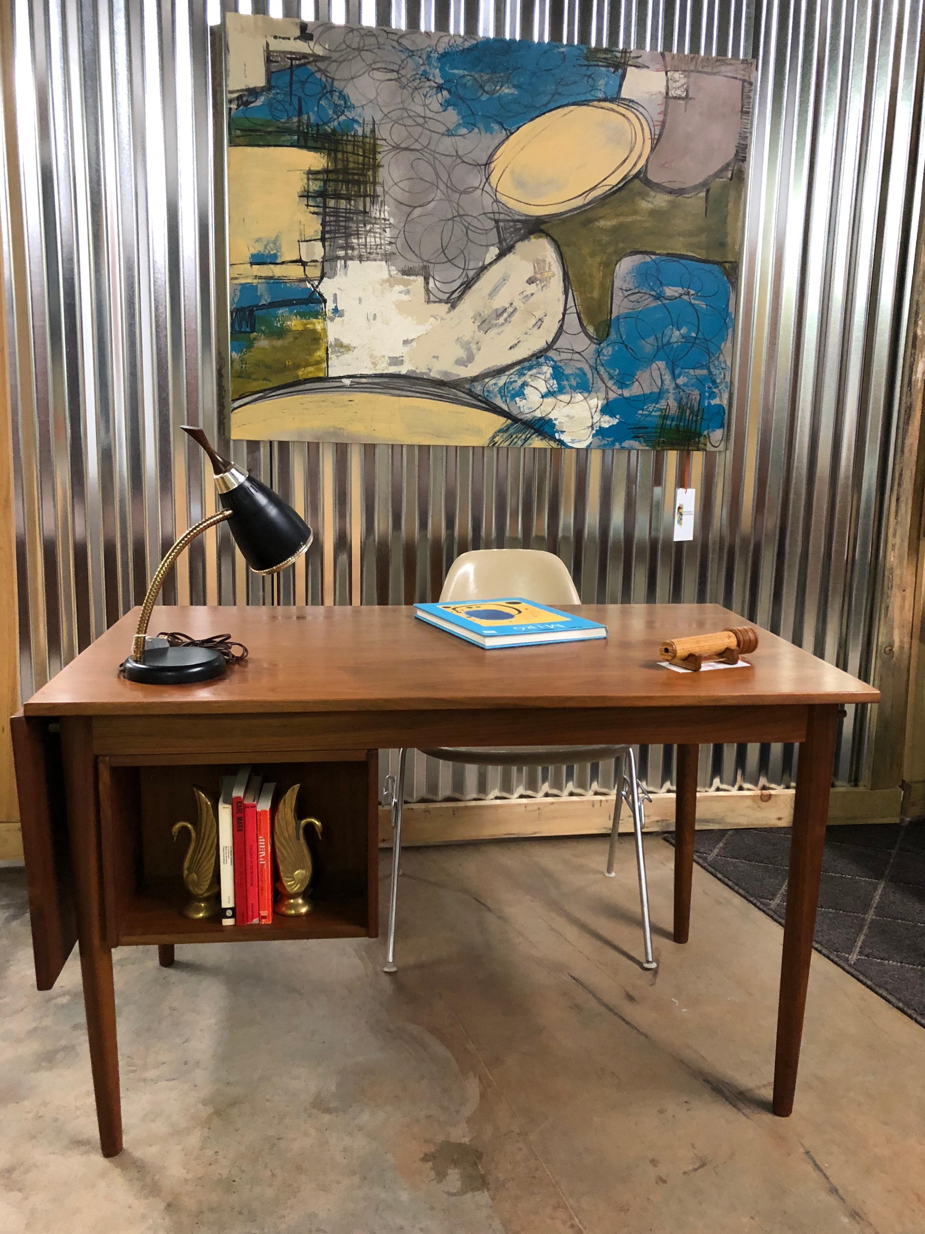 Midcentury Danish modern extendable and reversible teak desk by Arne Vodder. This very versatile desk is sure to fit your needs. Whether you need it to be short, long, right handed, or left handed this desk can accommodate you. The top has a drop
