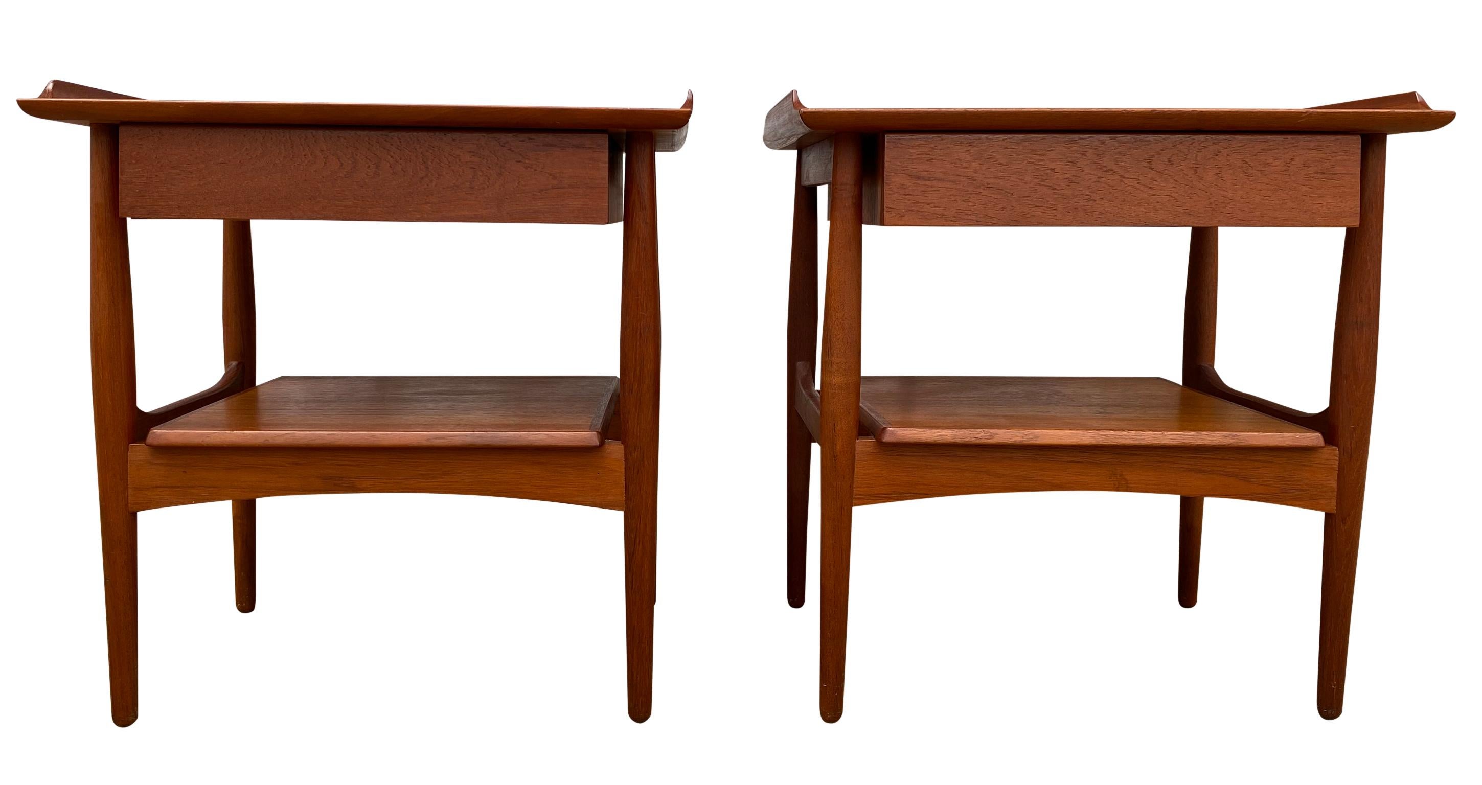 Beautiful pair of Danish modern teak nightstands lamp tables with single drawer Minimalist Professionally refinished. Very clean set of rare nightstands. Simple delicate design with tapered legs and lower shelf as well as a lipped top surface, all