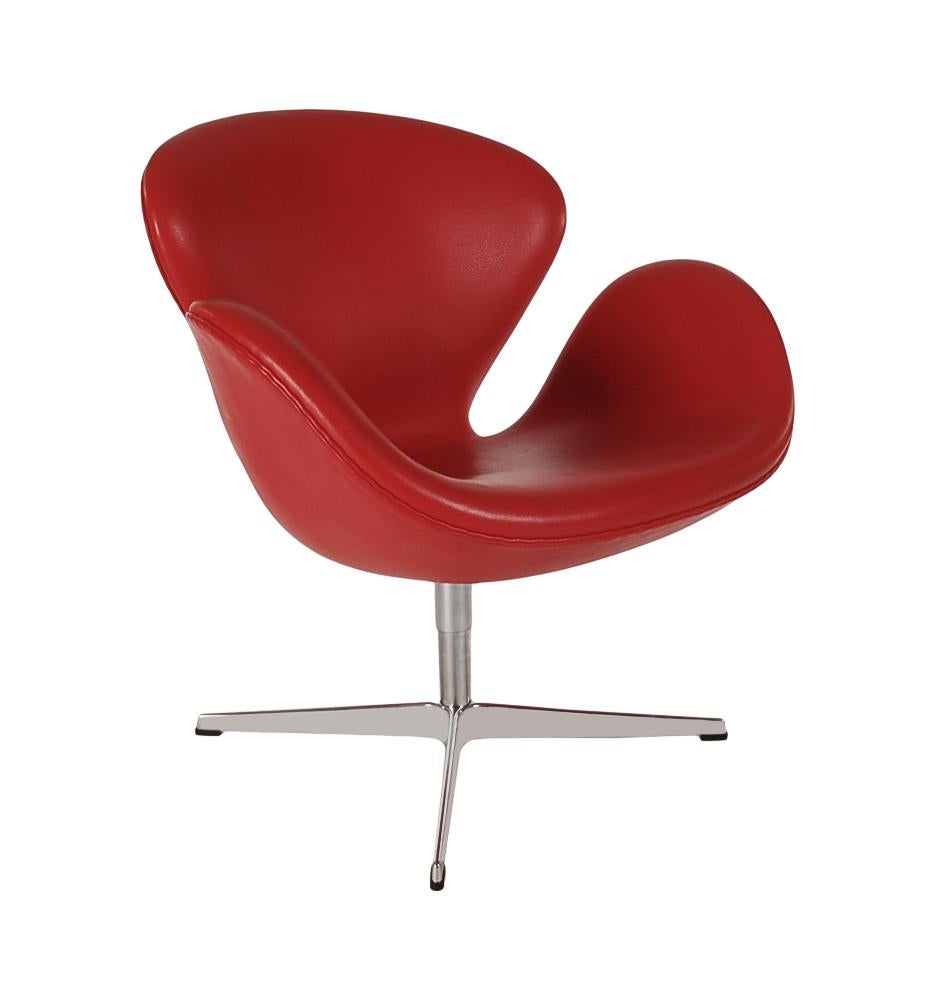 A matching pair of swan chairs designed by Arne Jacobsen and produced by Fritz Hansen in 2012. These are covered in supple red leather. They swivel and return to their original position automatically. These were lightly used in a commercial setting
