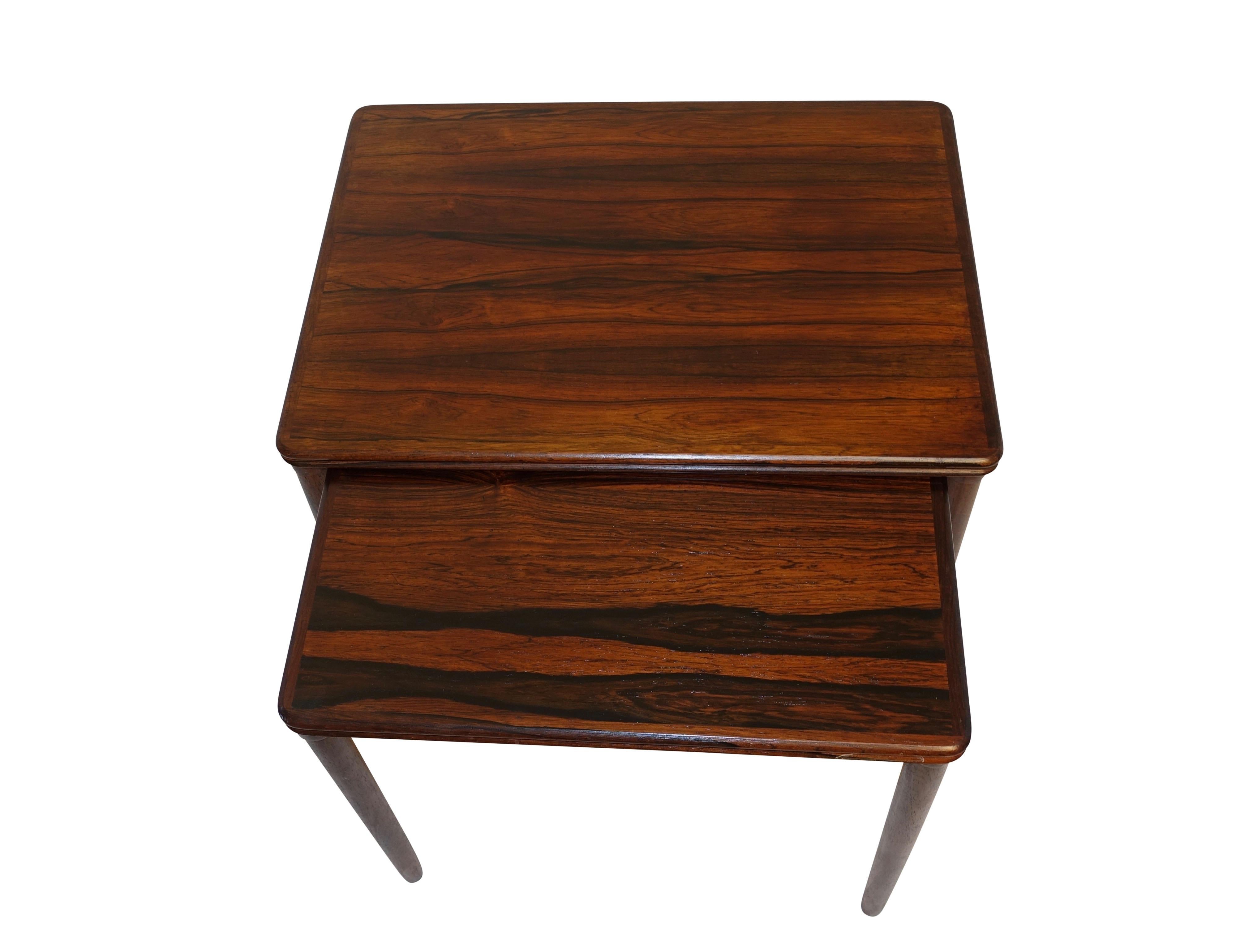 Two rosewood nesting tables with circular tapering legs. (Most likely originally a set of three). Mid-20th century, Danish modern, circa 1970.