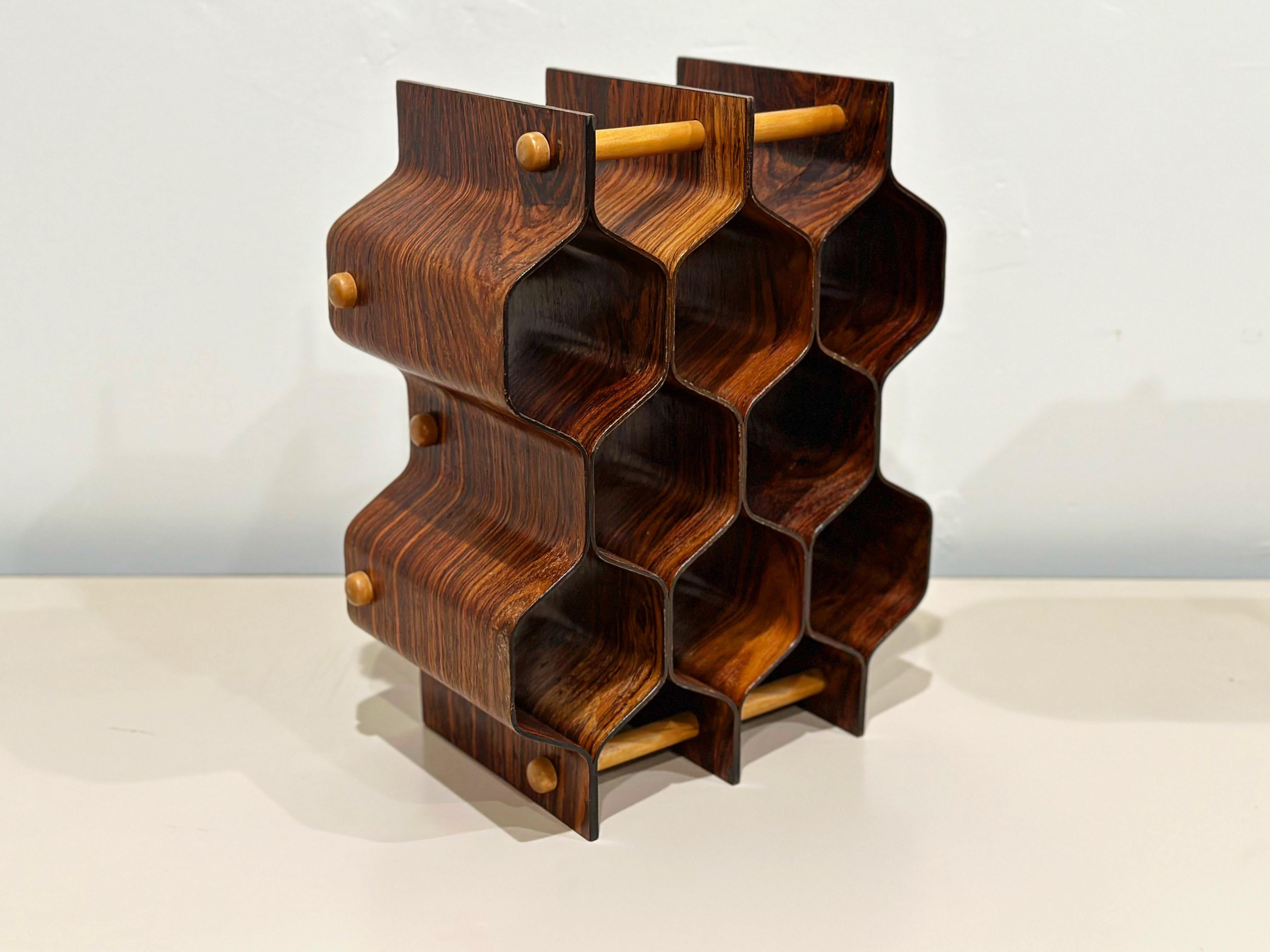 Sculptor, industrial designer and artist Torsten Johansson designed this beautiful wine rack of molded exotic rosewood and birch for AB Formträ, Sweden circa 1960s.