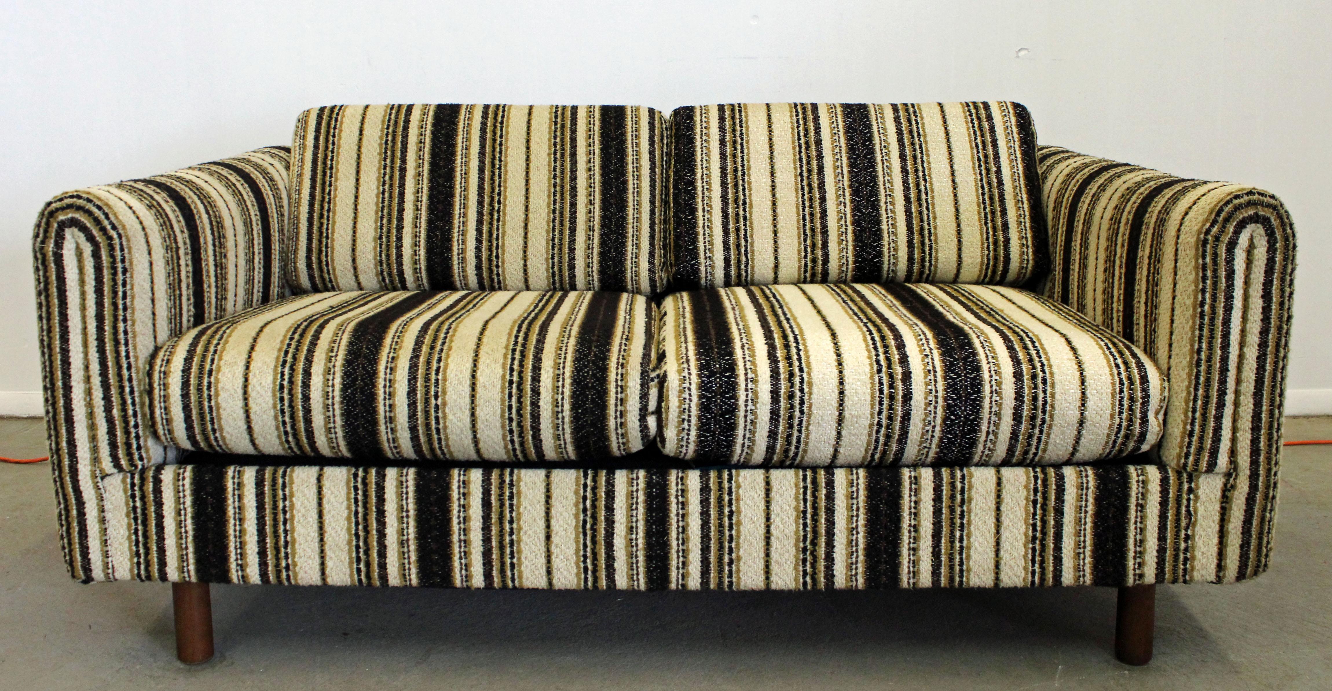 What a find. Offered is a Mid-Century Modern sofa made by Selig of Monroe. This is a loveseat with wooden legs. It is in excellent condition for its age, shows normal wear. It is signed. The sofa has the look of a high quality designer and will make