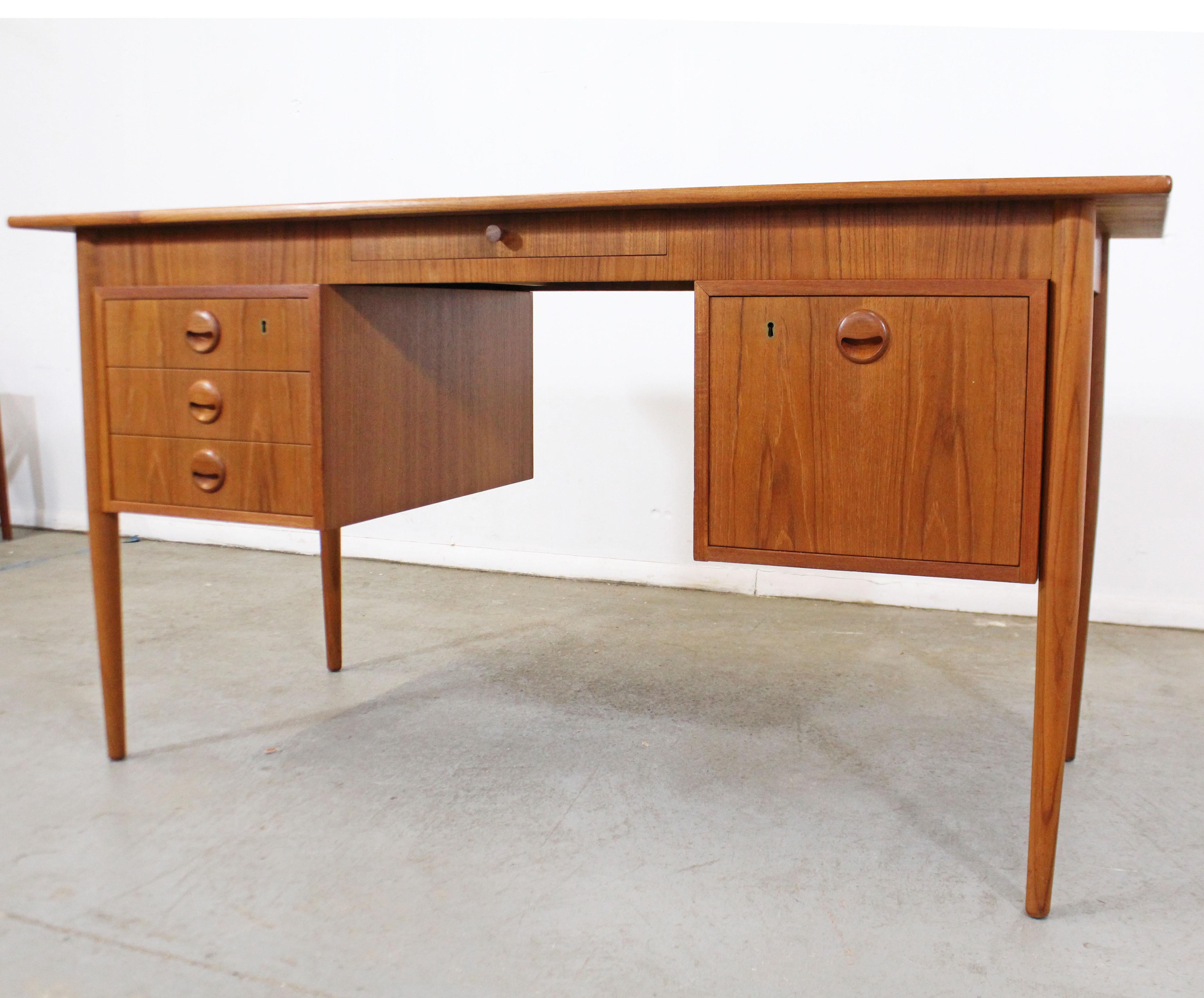 Offered is a super cool Danish modern teak desk by Svenstrup J for AP Mobler. This desk has one large file drawer, three smaller drawers, and one center drawer. In excellent condition for its age with some surface scratches and chips (see photos).
