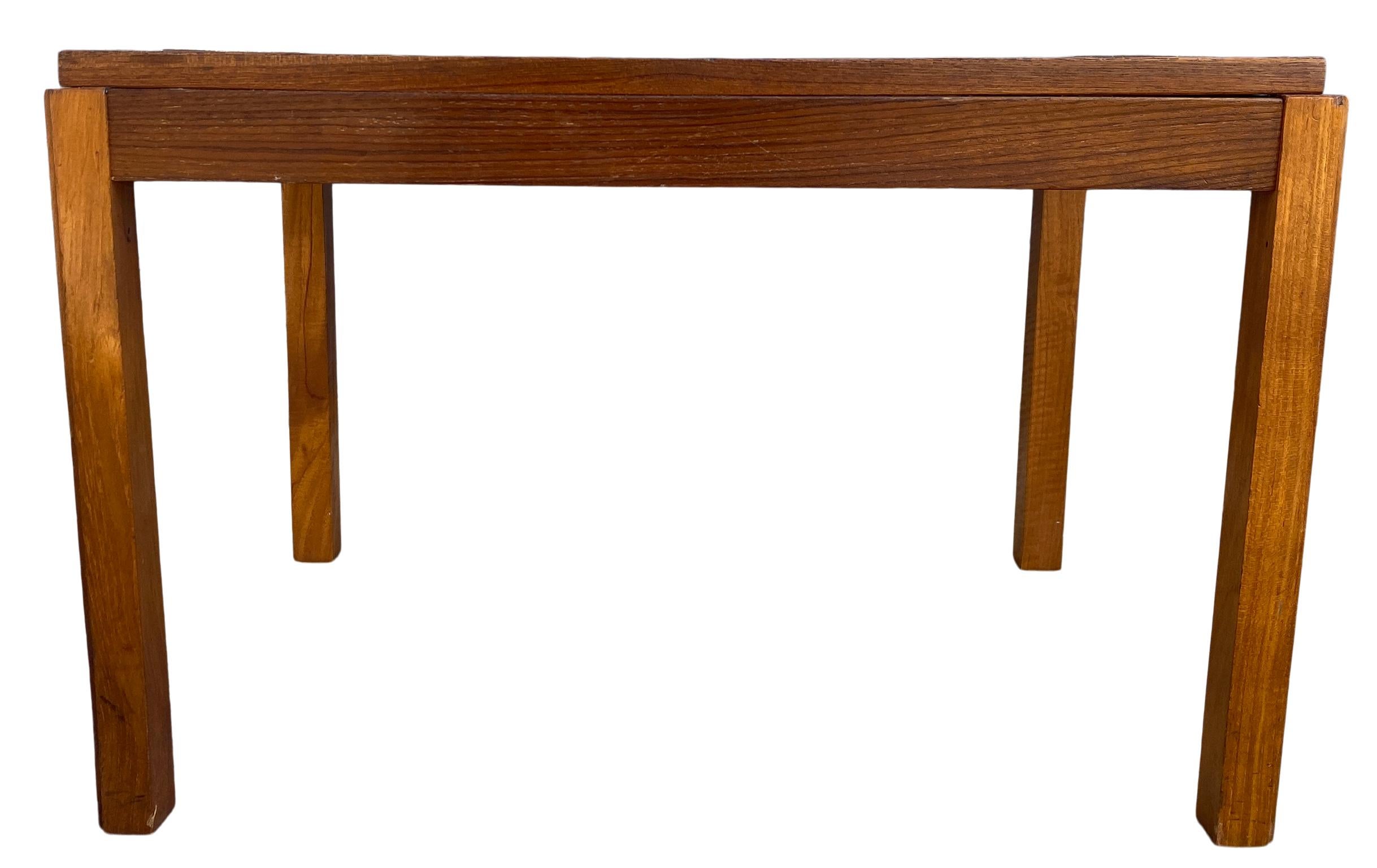 Midcentury Danish modern teak ceramic tile coffee table bench. Beautiful design and shape. Has beautiful ceramic tiles mounted in the top of the coffee table. Solid hardwood construction. Great vintage condition - very solid and sturdy.