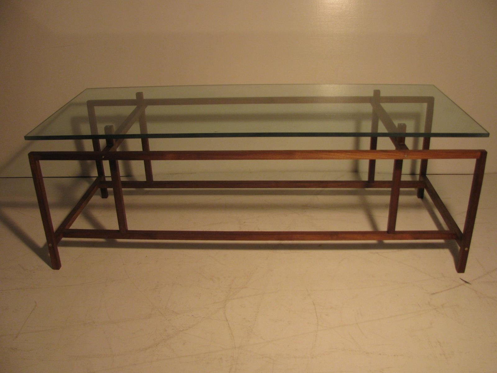 Beautiful with simple architectural lines which make up this elegant piece. Glass top fits snugly into pins which lock it into place, pins only go in halfway so glass remains smooth on the top. Table is well constructed and remains tight. Pair
