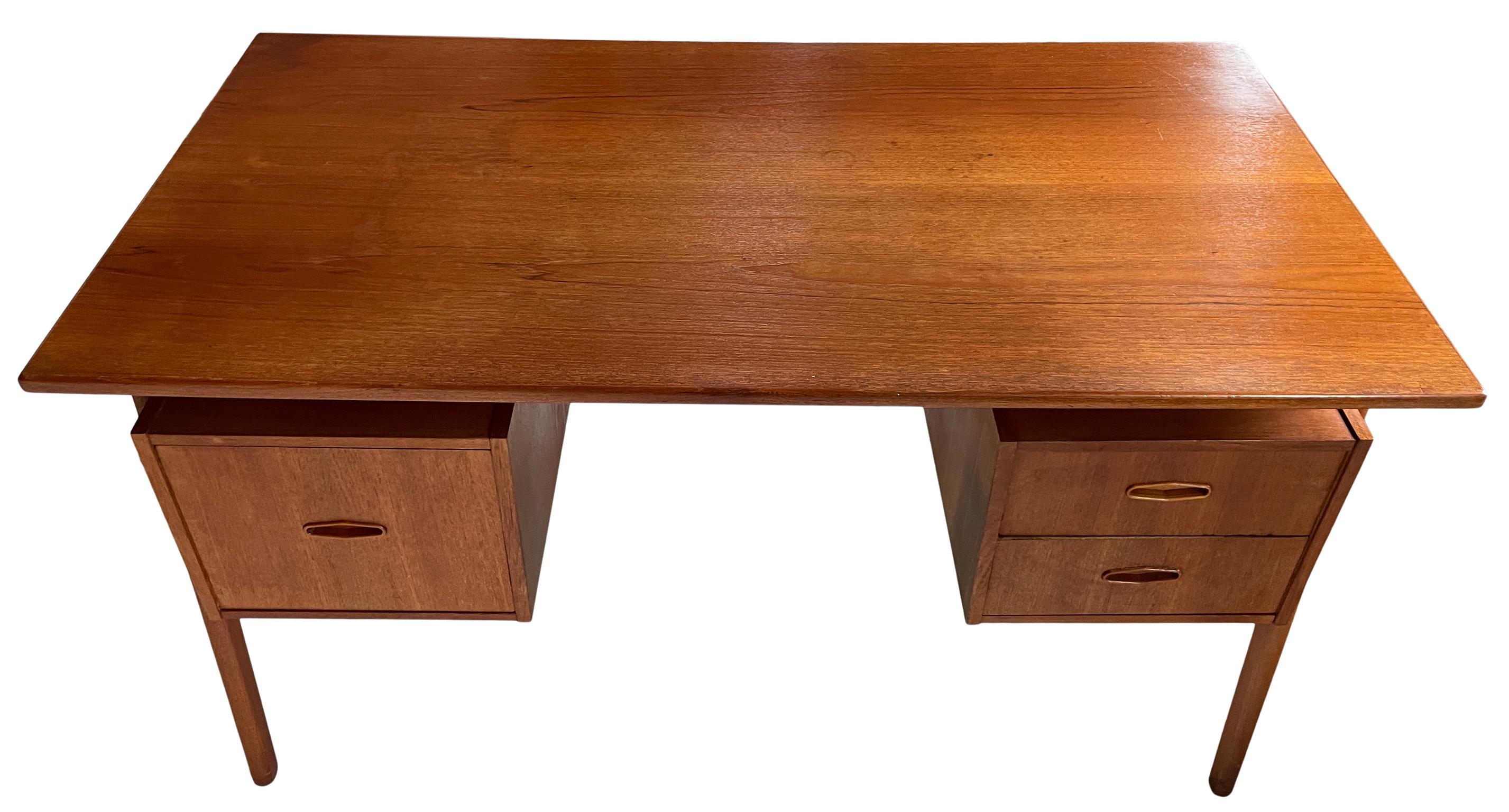 Great Danish modern mid century desk with 3 drawers with carved pulls. Danish design. No labels, made in Denmark. Kneehole cabinet has original Key - Lockable. All drawers slide smooth great design. Front side of desk has storage areas. Located in