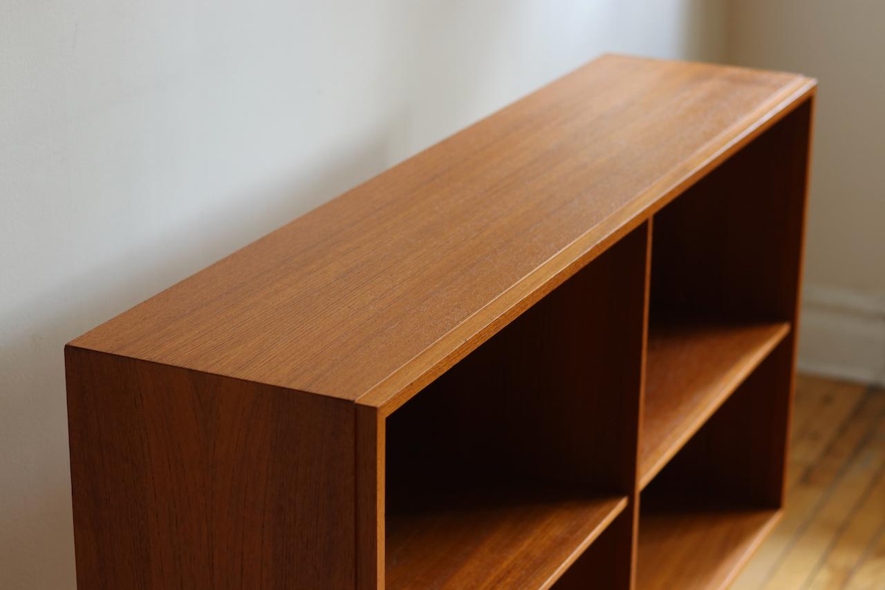 Midcentury Danish modern teakwood bookcase or record storage.
Just imported from Copenhagen!
Refinished gorgeous teak woodgrain.
Adjustable shelving.
Beveled edge along the front.
Excellent vintage condition!
Measures: 47 1/4” long x 11 1/8”