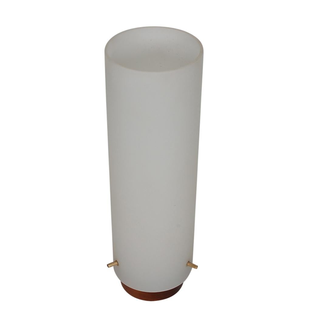 A simple and elegant pair of cylinder table lamps. The feature walnut bases, frosted glass shades, and brass set pins. Both are in clean and working condition.
