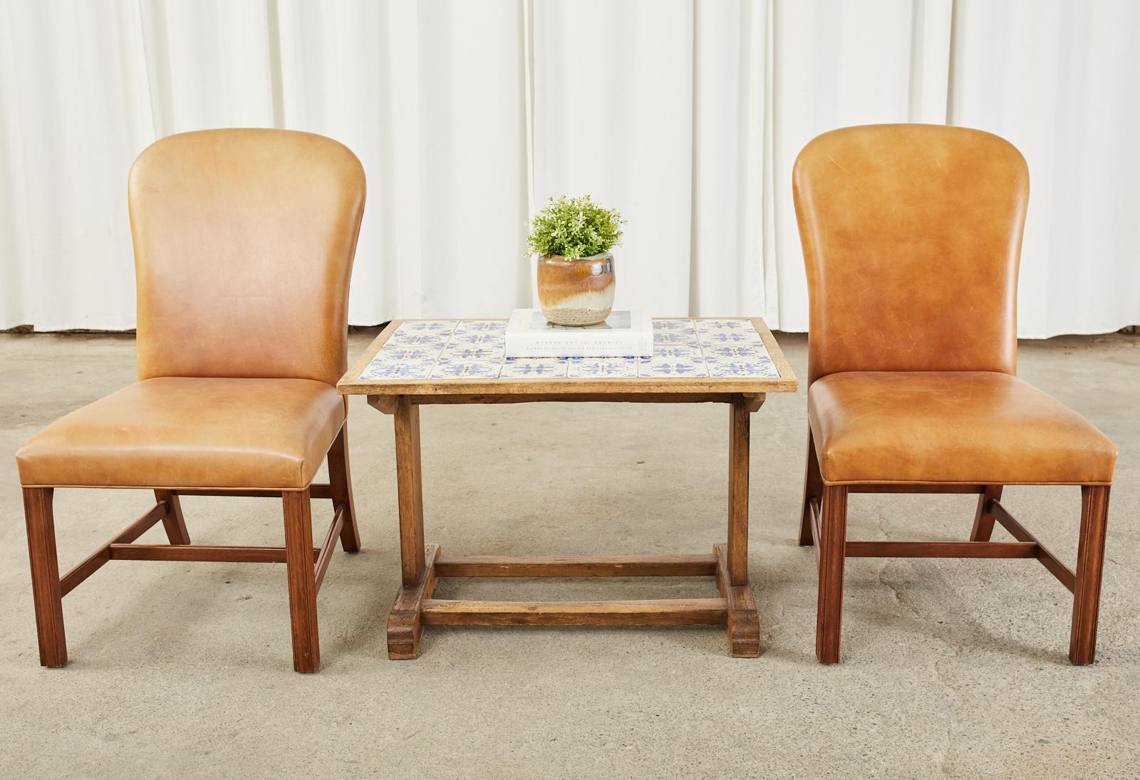 Charming and attractive mid-century modern danish oak coffee or cocktail table featuring a blue and white hand-painted tile top. The oak frame is crafted with mortise and tenon joinery with a trestle style base. Beautifully crafted with an aged