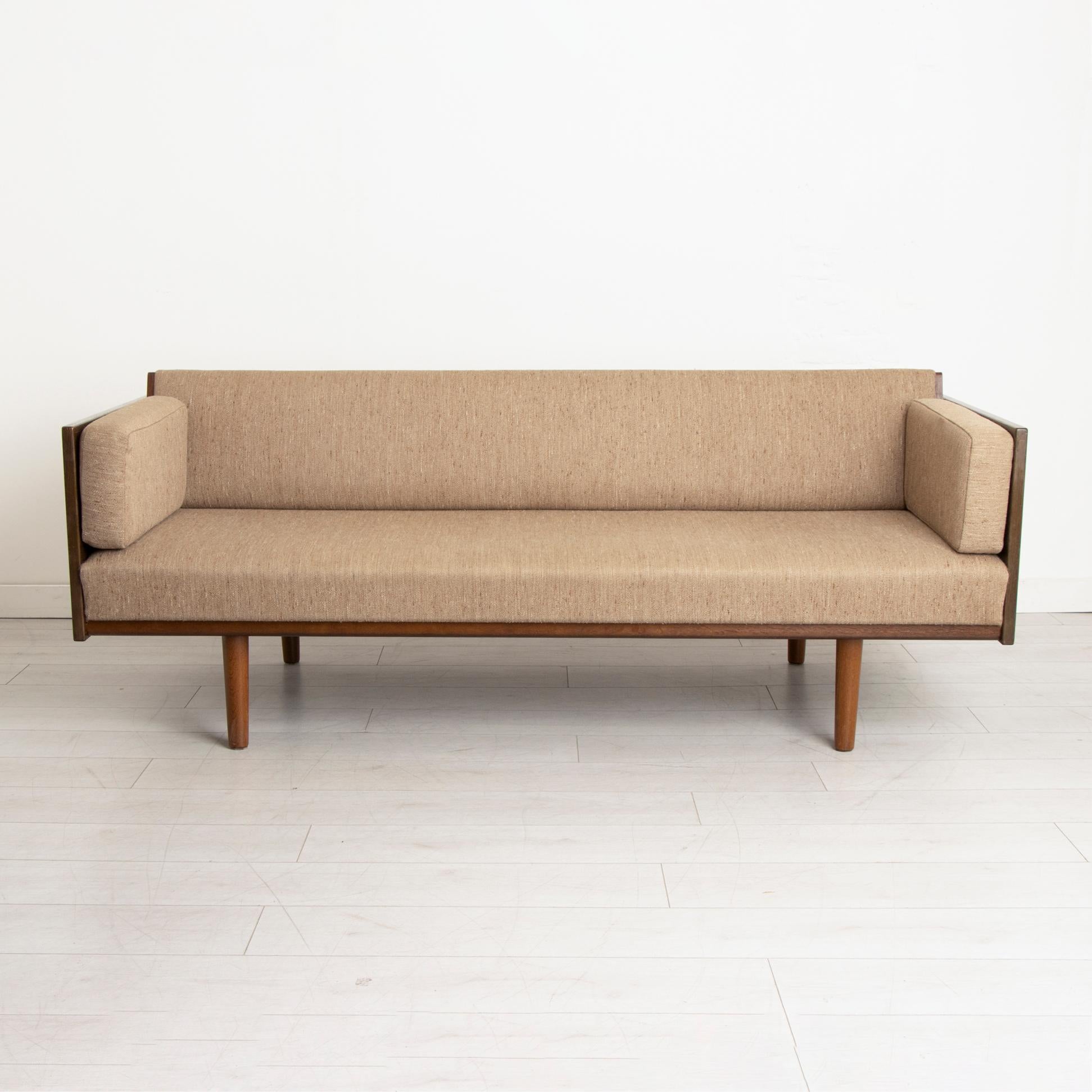 A midcentury Danish sofa bed designed by Hans J Wegner for Getama model GE6 made in oak and teak. Very rare early model. Stain to interior sheet.