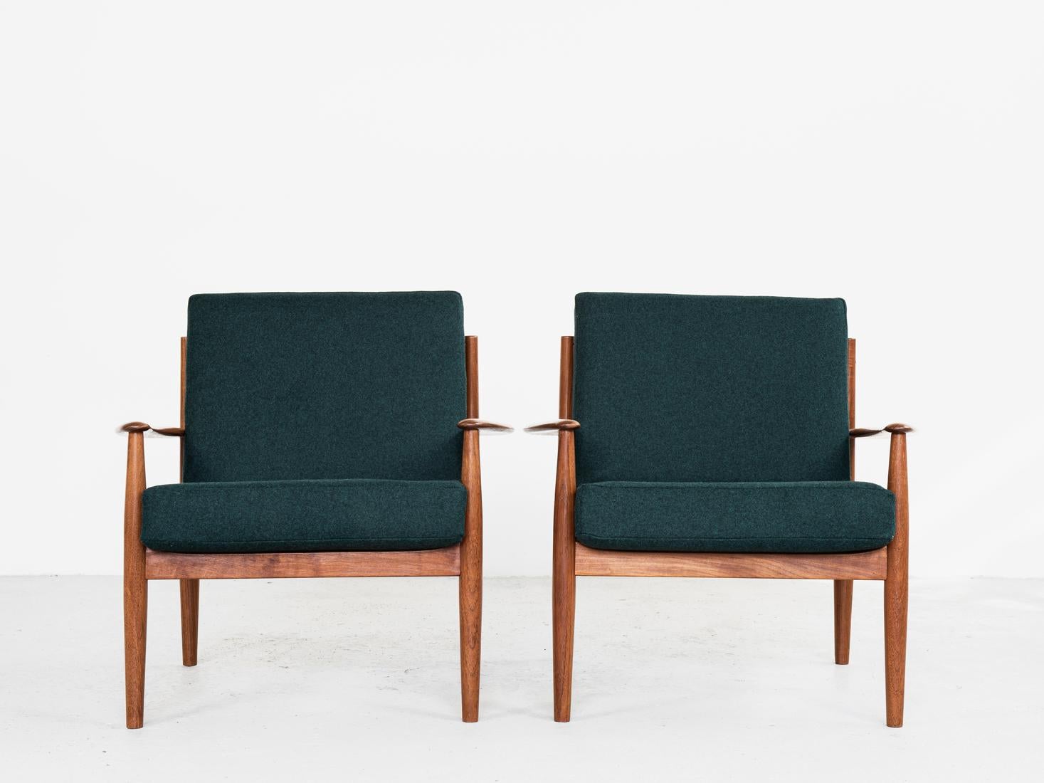 Midcentury pair of easy chairs designed by Grete Jalk and manufactured by France & Søn in Denmark in the 1960s. The chairs are labelled by the manufacturer. They are made of solid teak and have new cushions and fabric of good quality: dark green