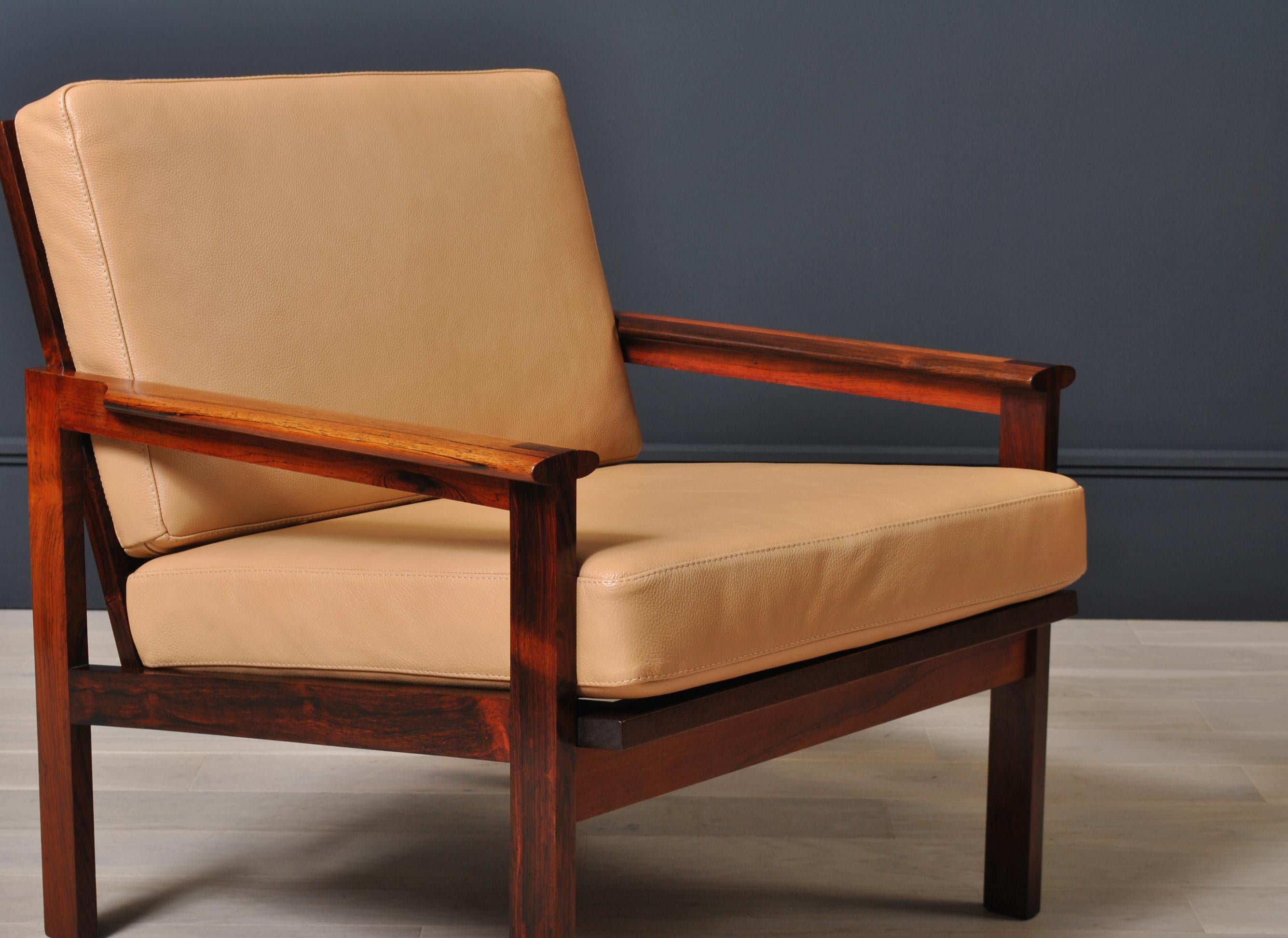 A classic midcentury Danish armchair. These ‘Capella’ chairs were designed by Illum Wikkelso for N. Eilersen in Denmark during the early 1960s. Superb design with beautiful block joints to arms. Professionally reupholstered in fine tan Crest