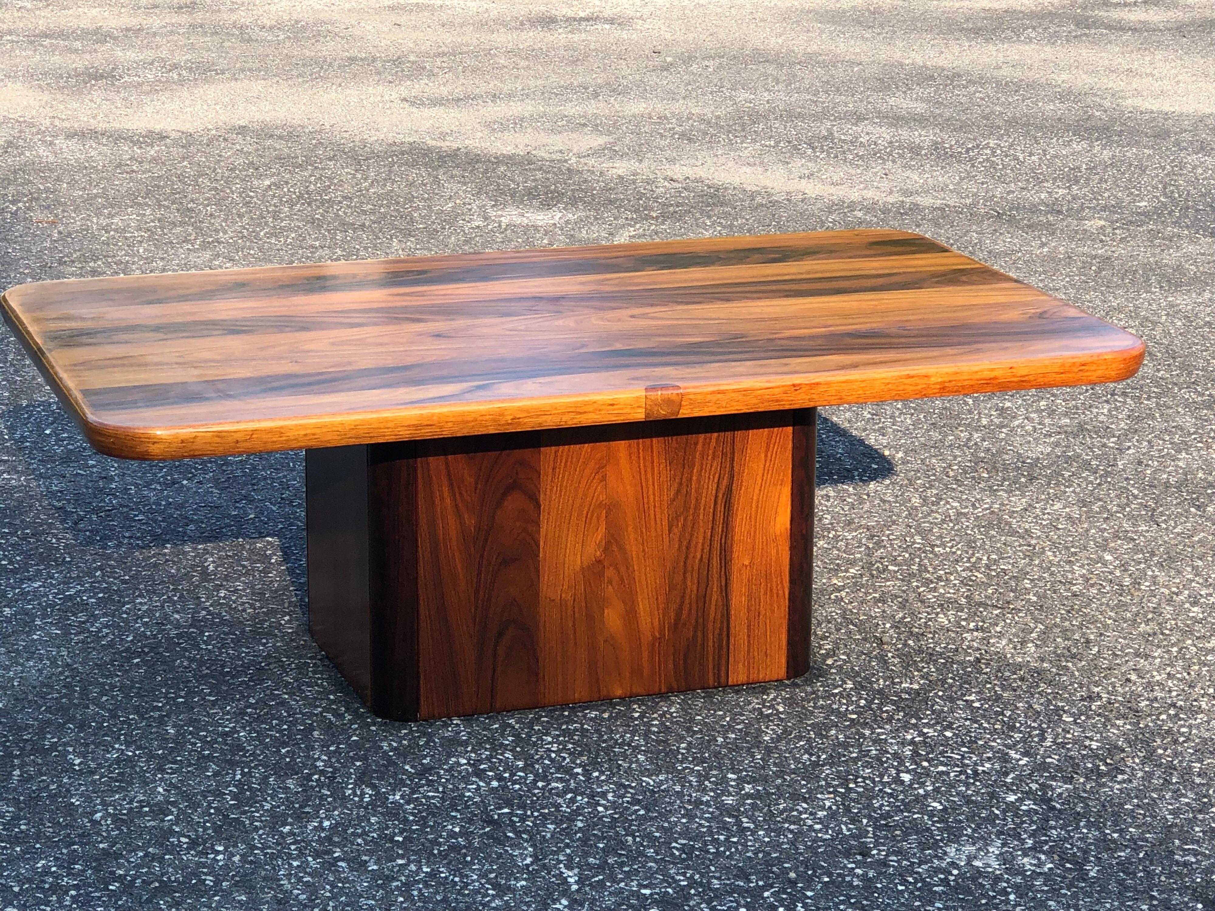 Midcentury Danish rosewood coffee table by Jensen Frokjaer. Minimalist lines and rich, organic wood grains make up this perfect sized coffee table. Its rounded edges and block base make it kid and pet friendly. It is solid, very sturdy and timeless