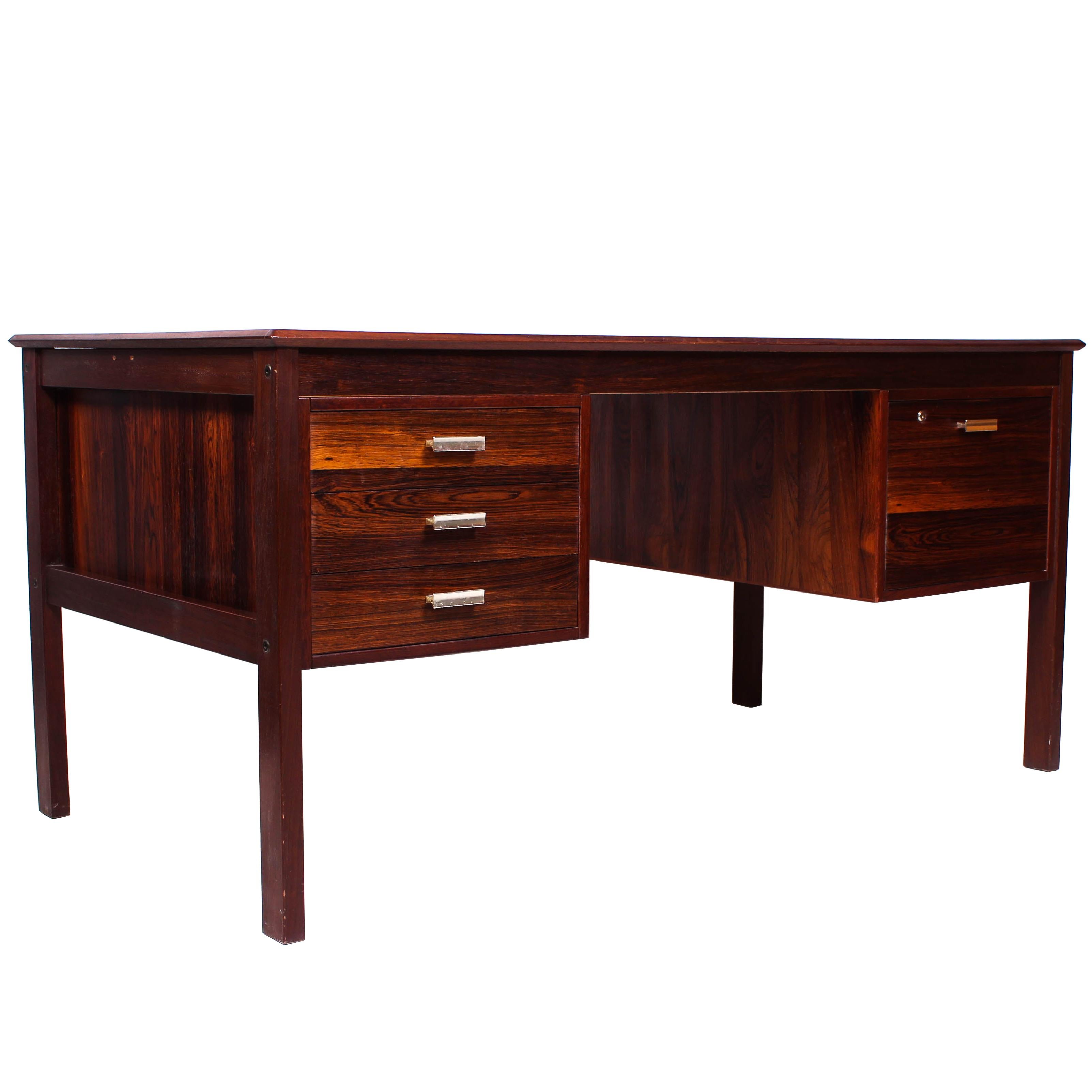 A midcentury rosewood desk by unknown designer. The desk is of high quality with a veneered back so that it can be placed in an open space as well as against a wall. 

Very good vintage condition with signs of usage consistent with age and use.