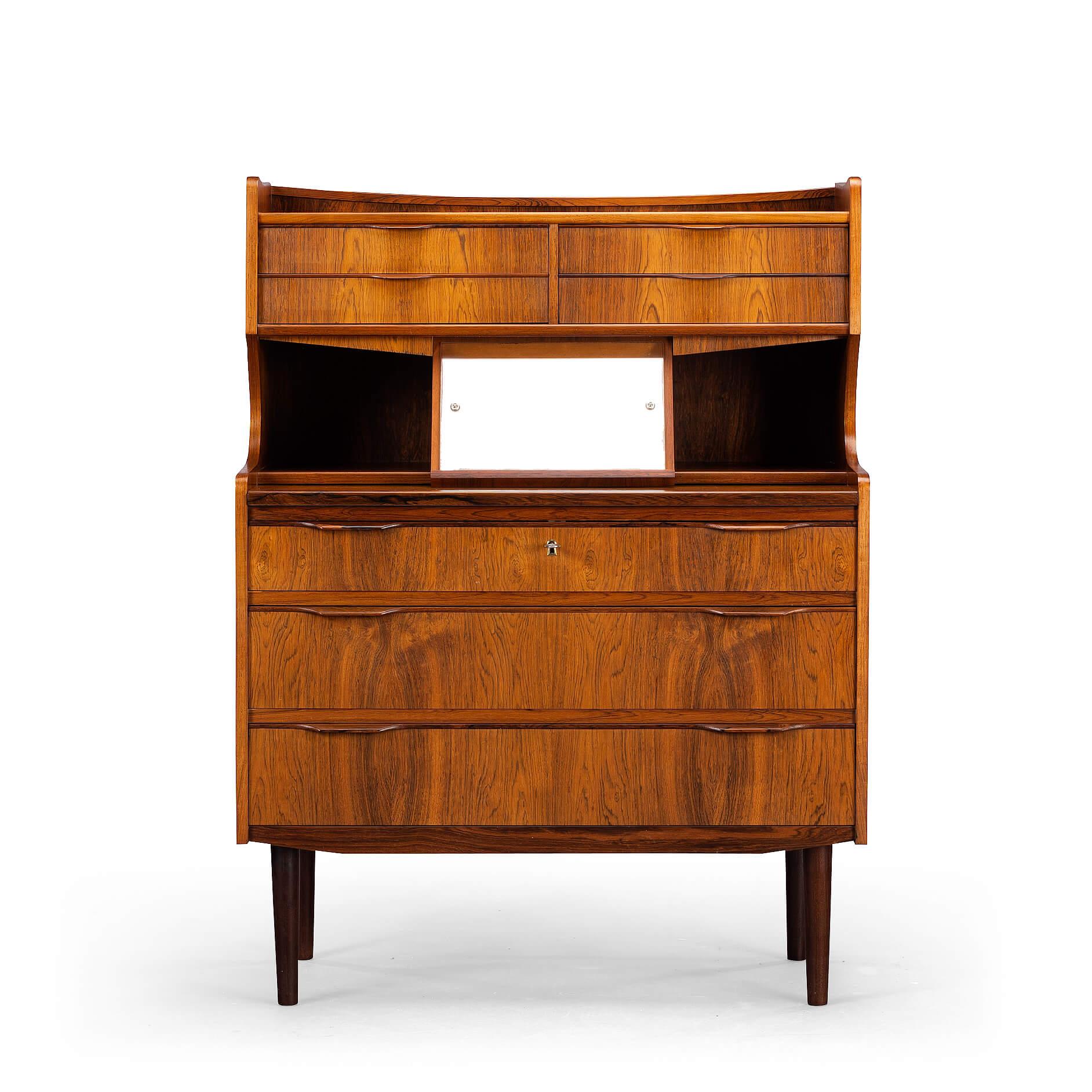 Easy does it: a writing desk when you want it to be one! This writing desk has it all is made in rosewood veneer and has a pull out desk. Could beauty up your living room and transform into a working station if you need it. And check out the hidden