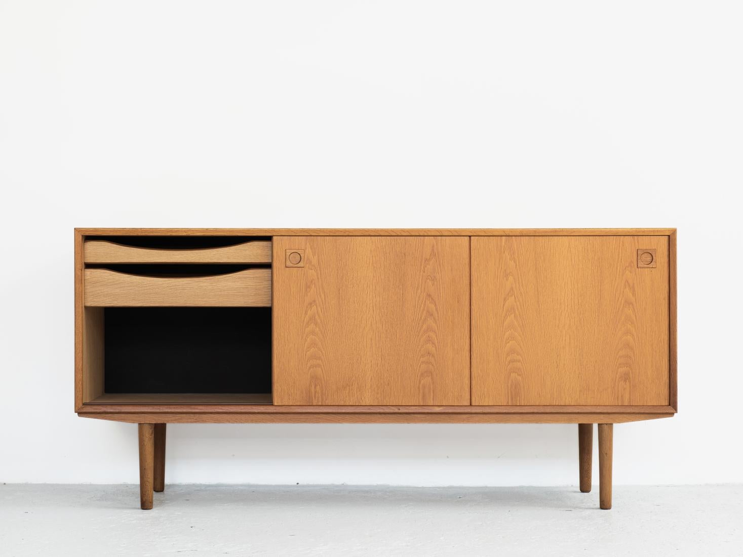 Midcentury sideboard made by Skovby Møbelfabrik in Denmark in the 1960s. It is a compact model. It is labelled by the manufacturer in the back. The sideboard has 3 sliding doors and 2 inner drawers. Overall use of very good quality materials. The