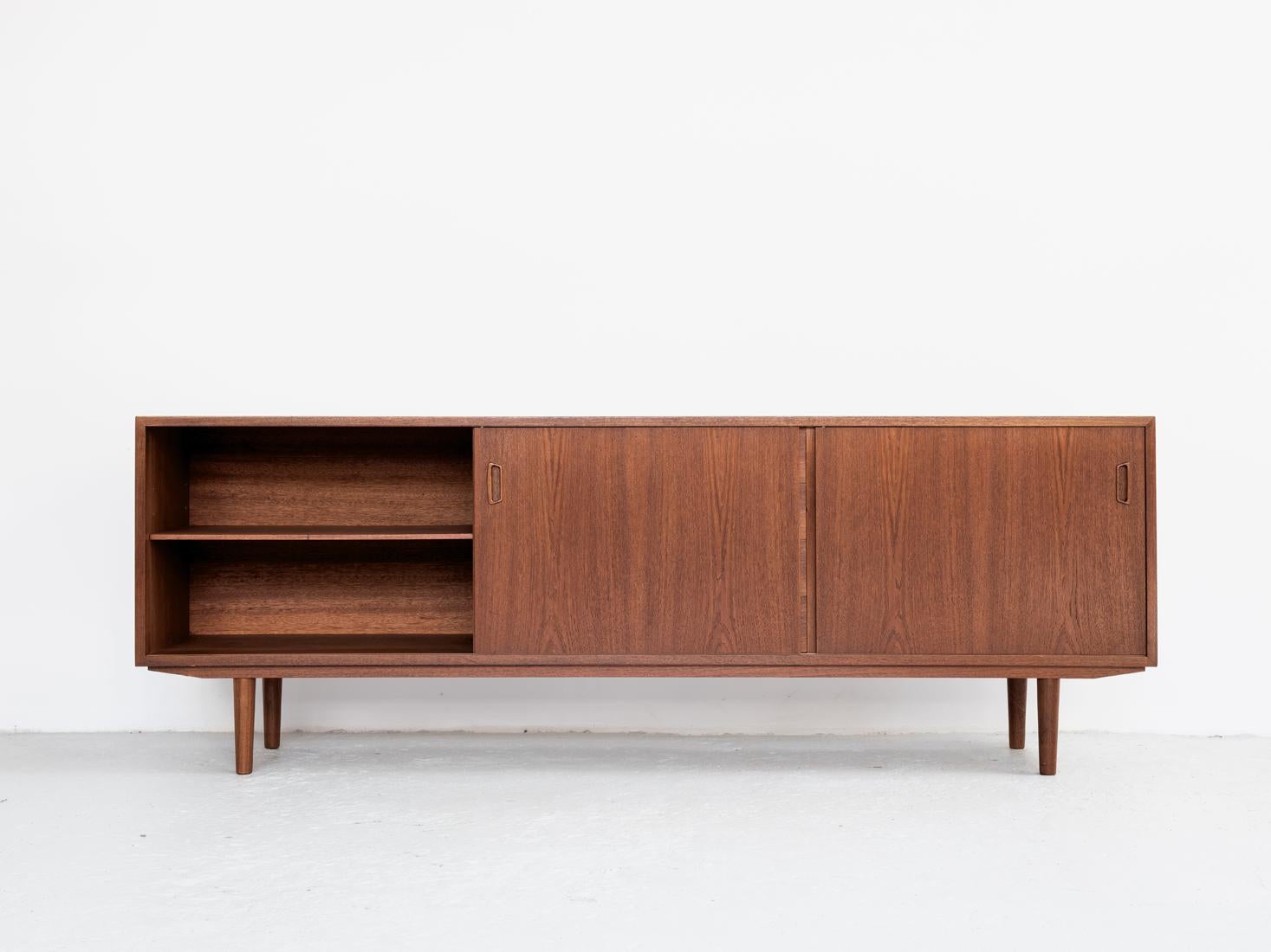 Midcentury sideboard manufactured by Hornslet Møbelfabrik in Denmark in the 1960s. It is an extra low model. This piece has 2 sliding doors and 4 drawers in the middle. It has been labelled by the manufacturer in the back. The sideboard is made of