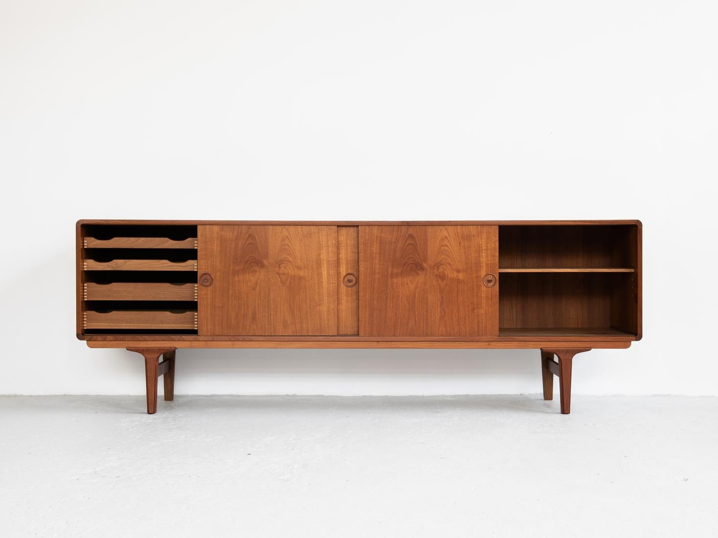 Midcentury sideboard made in Denmark in the 1960s. The sideboard has rounded edges and very beautiful drawings in the wood. It has 4 sliding doors and inside 2 smaller and 2 bigger drawers. It is labelled in the back: made in Denmark. The sideboard