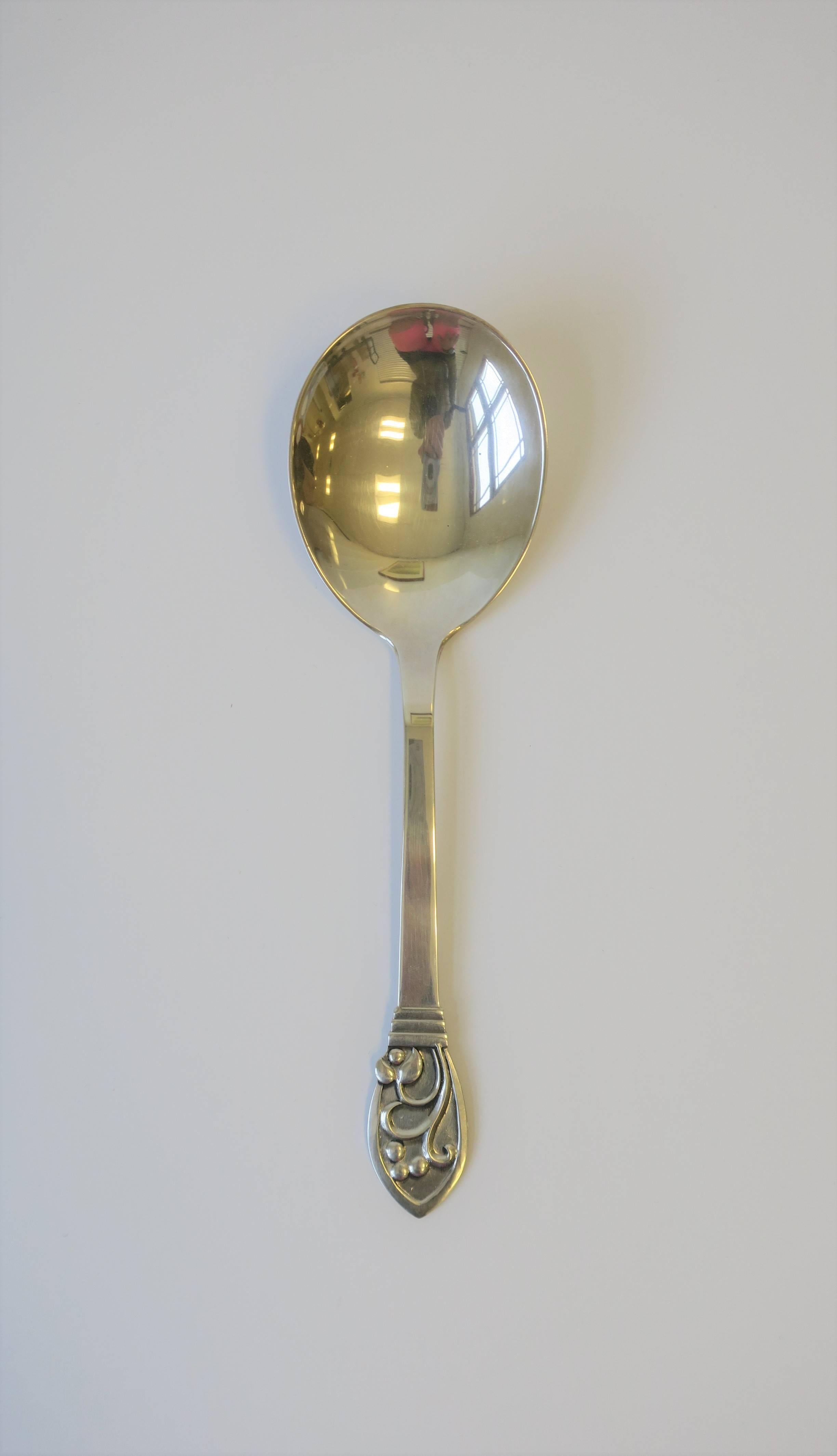 A beautiful vintage Danish sterling silver serving spoon with decorative handle in the organic modern style, circa mid-20th century, Denmark. Spoon is with maker's mark and marked '