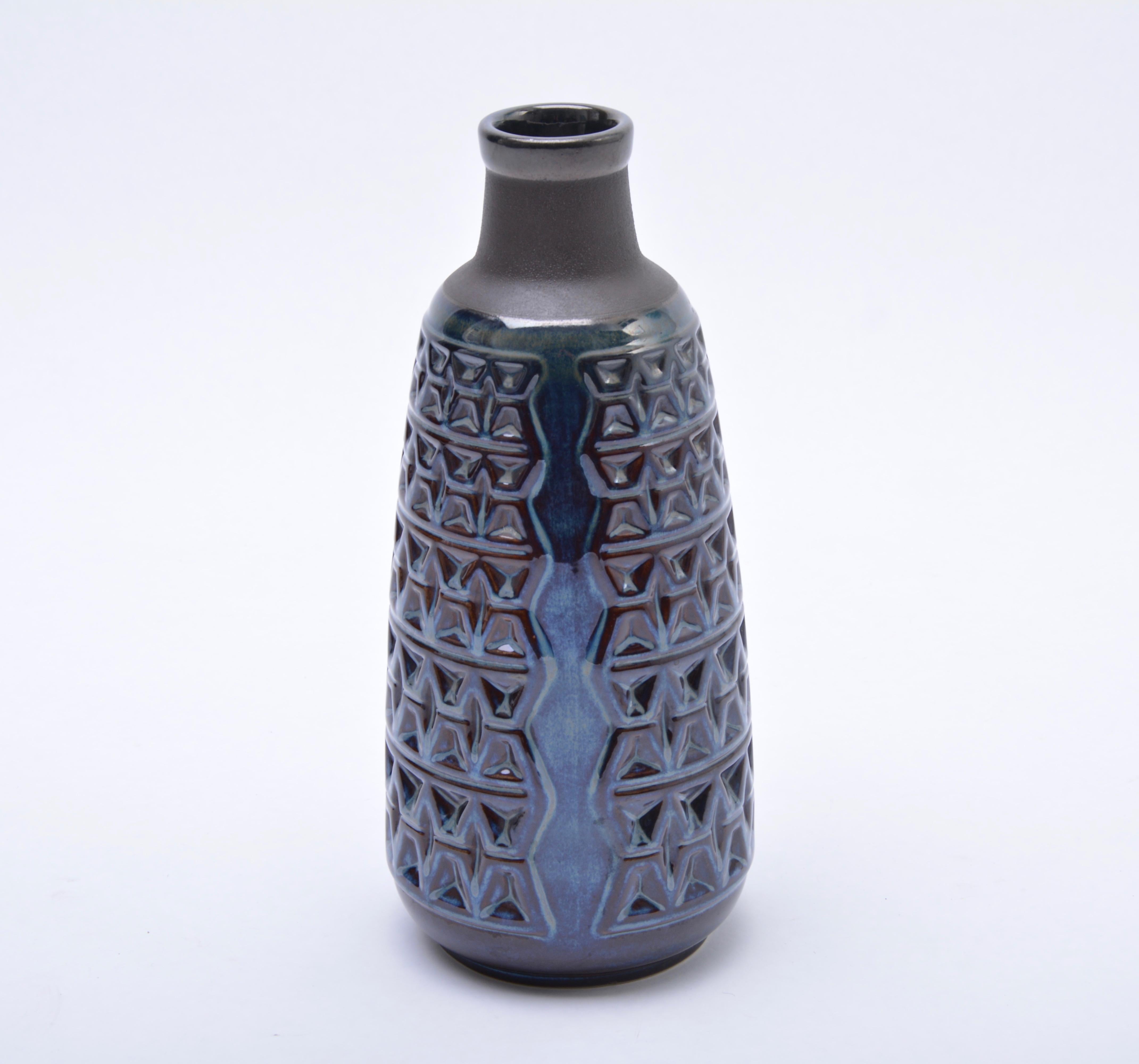 This large vase is made of stoneware and features ceramic glazing in various tones of blue. It was designed by Einar Johansen and was produced in Denmark by Soholm. Søholm was founded in 1835, in Rønne, Bornholm which is famous for its pottery and