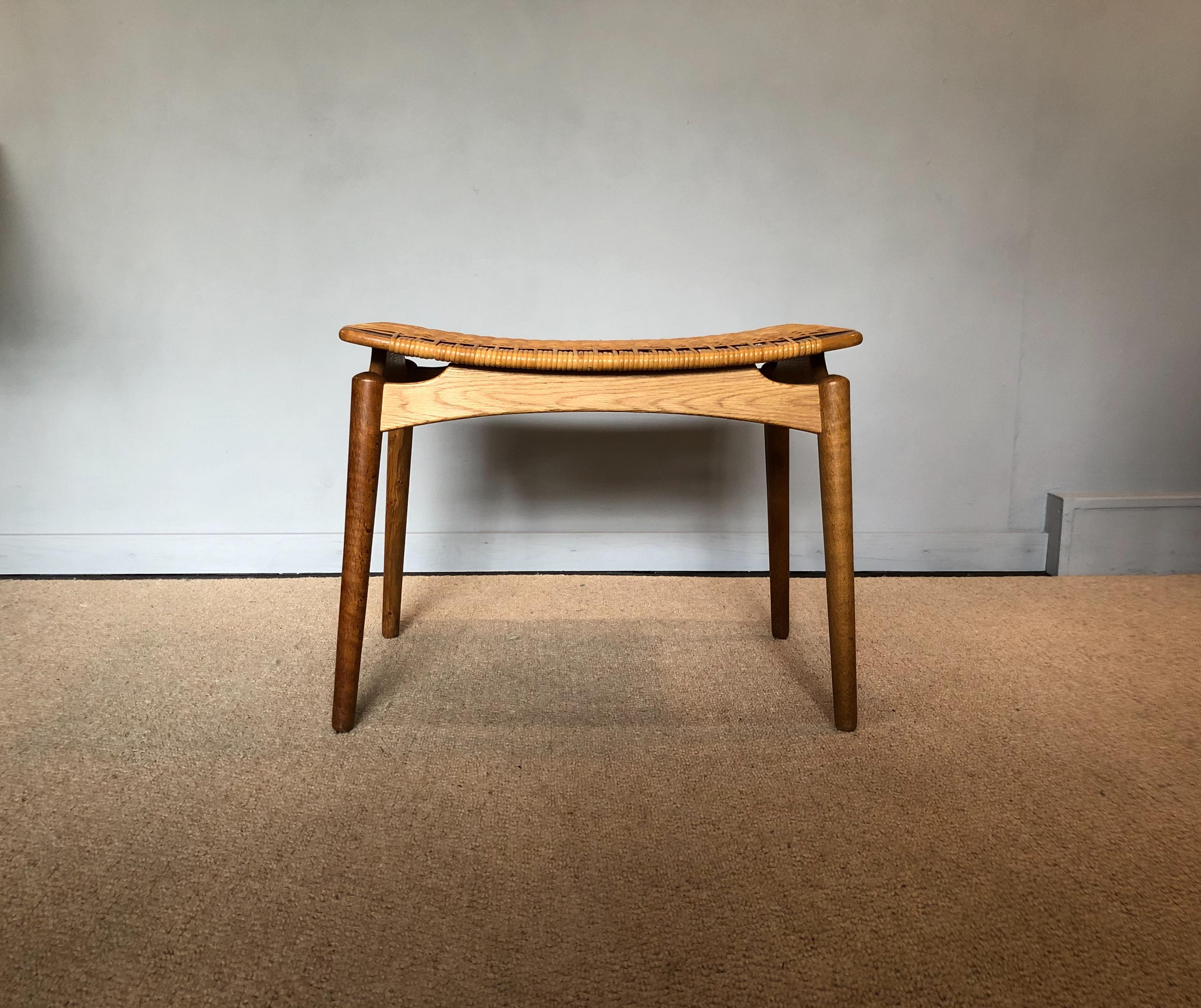 Incredibly elegant oak and cane Midcentury Danish stools by renowned designer Finn Juhl for Niels Vodder. Wonderful pieces. Produced in the late 1950s-1960s. The cane weave can be changed and reupholstered by us if a different fabric or Leather