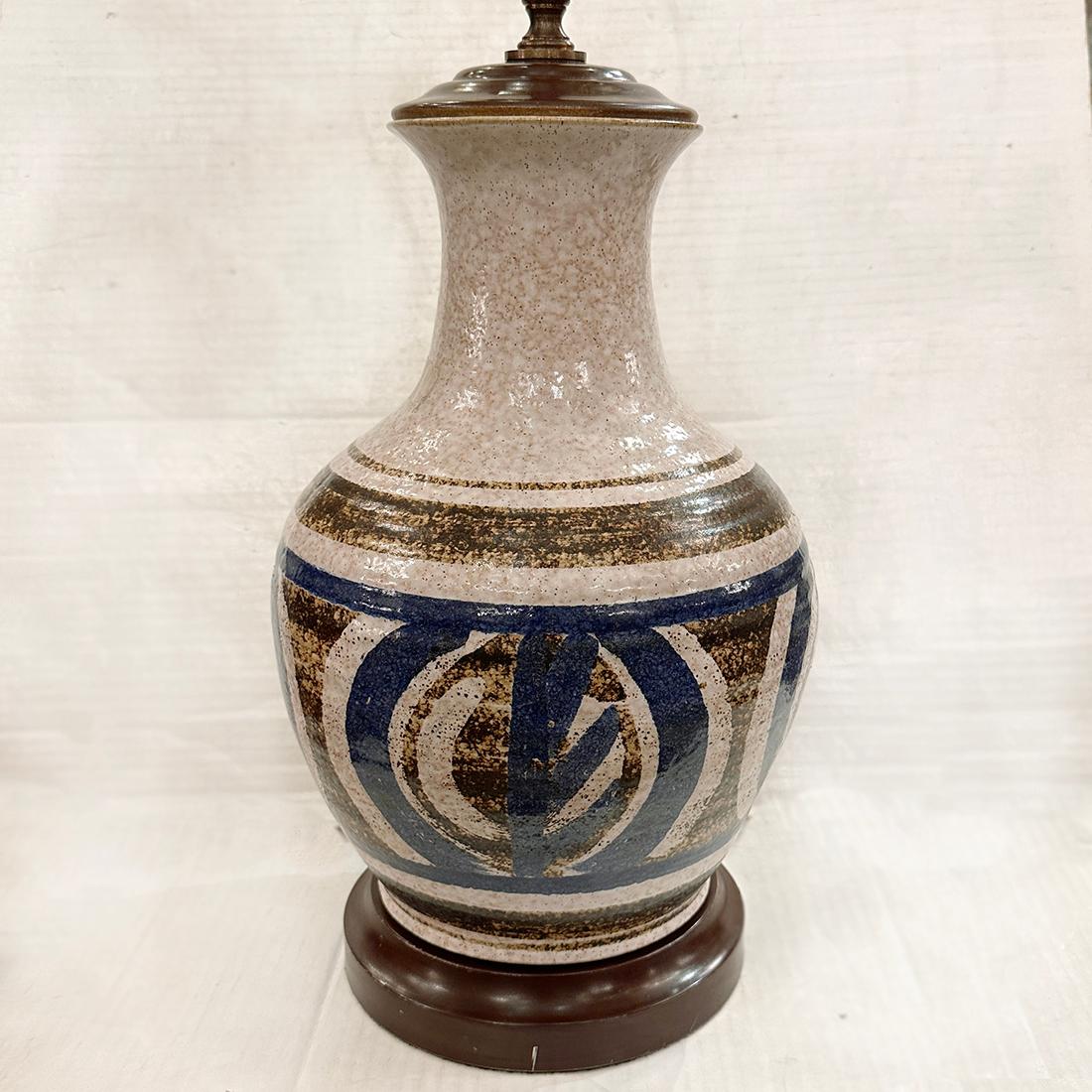 A circa 1960's Danish porcelain table lamp with wood base.

Measurements:
Height of body: 17