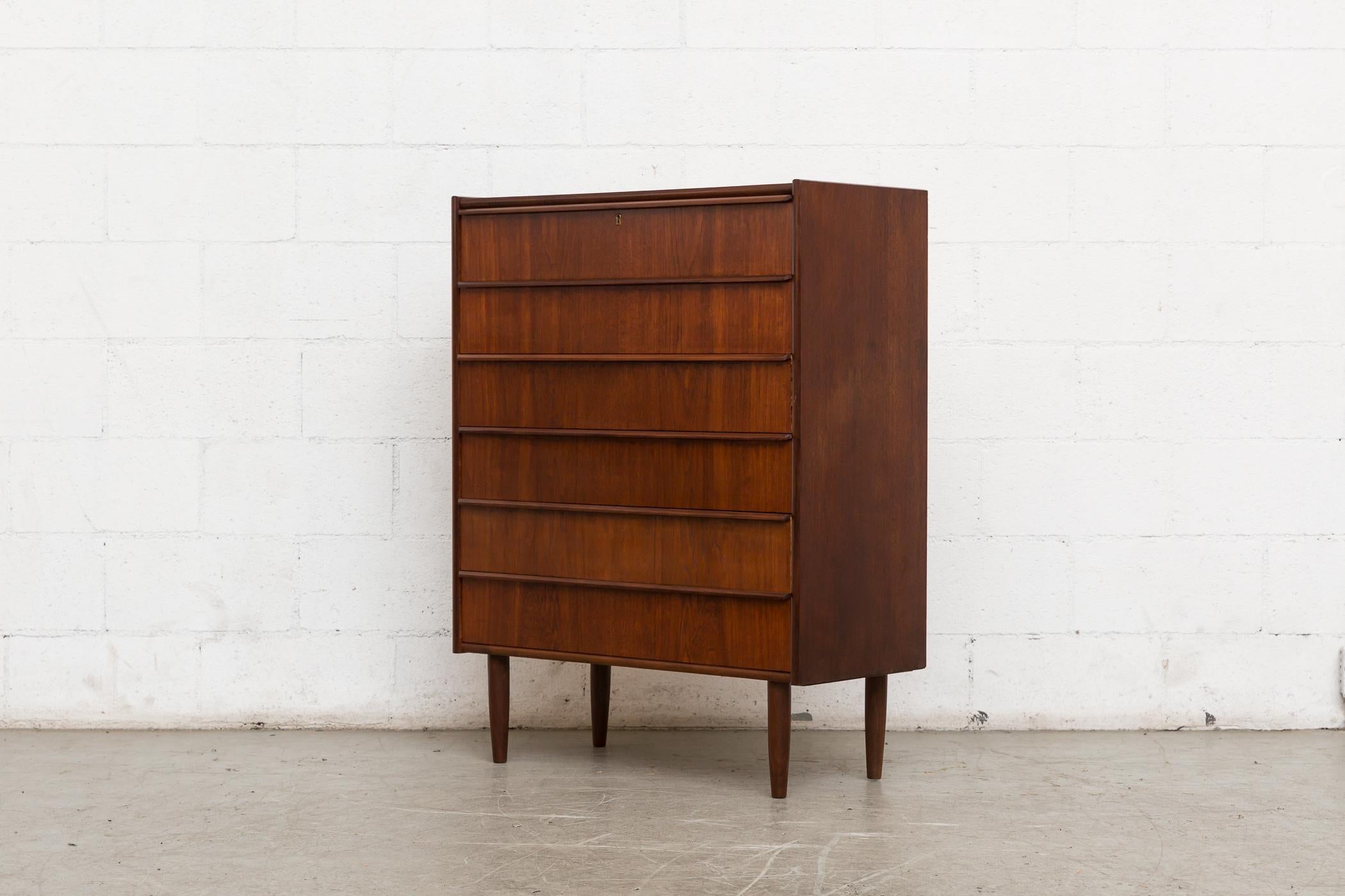 Midcentury Danish teak dresser with six drawers and organically carved linear hand pulls. Tapered legs. Lightly refinished. Good original condition, Denmark, 1960s.