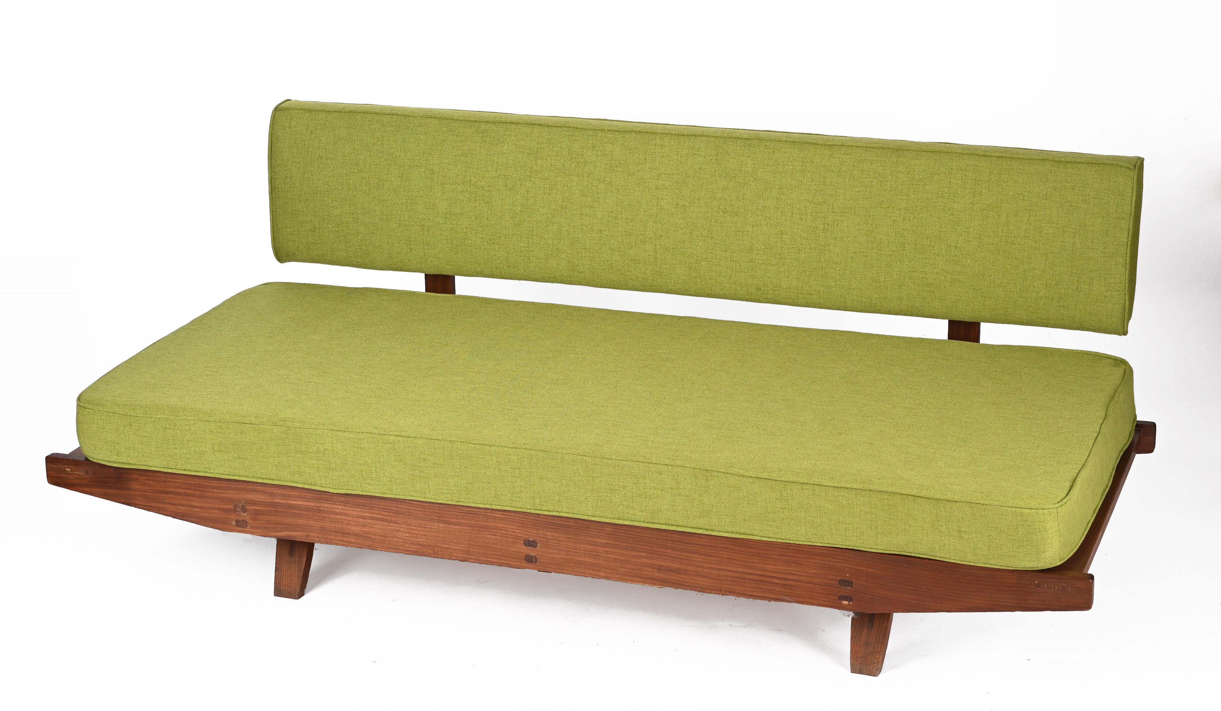 Fantastic midcentury teak and sage green fabric extendable sofa. This incredible piece was designed in Denmark after Hans Olsen during the 1960s.

This item has a magnificent teak wood structure, with an extendable seat with completely restored