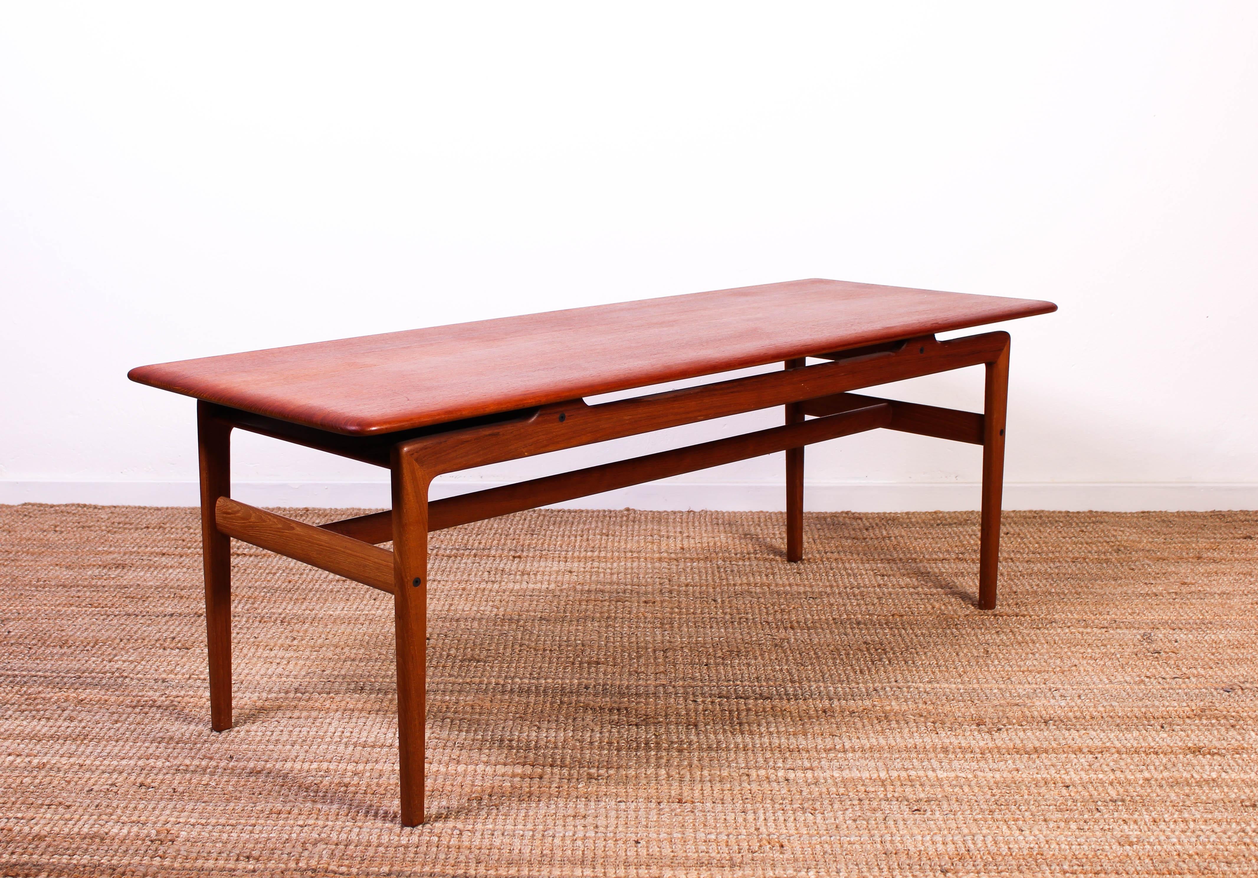 Midcentury Danish coffee table made of solid teak. Designed by Peter Hvidt and Orla Mølgaard Nielsen in the 1950s. 

Very good vintage condition with only small signs of usage.