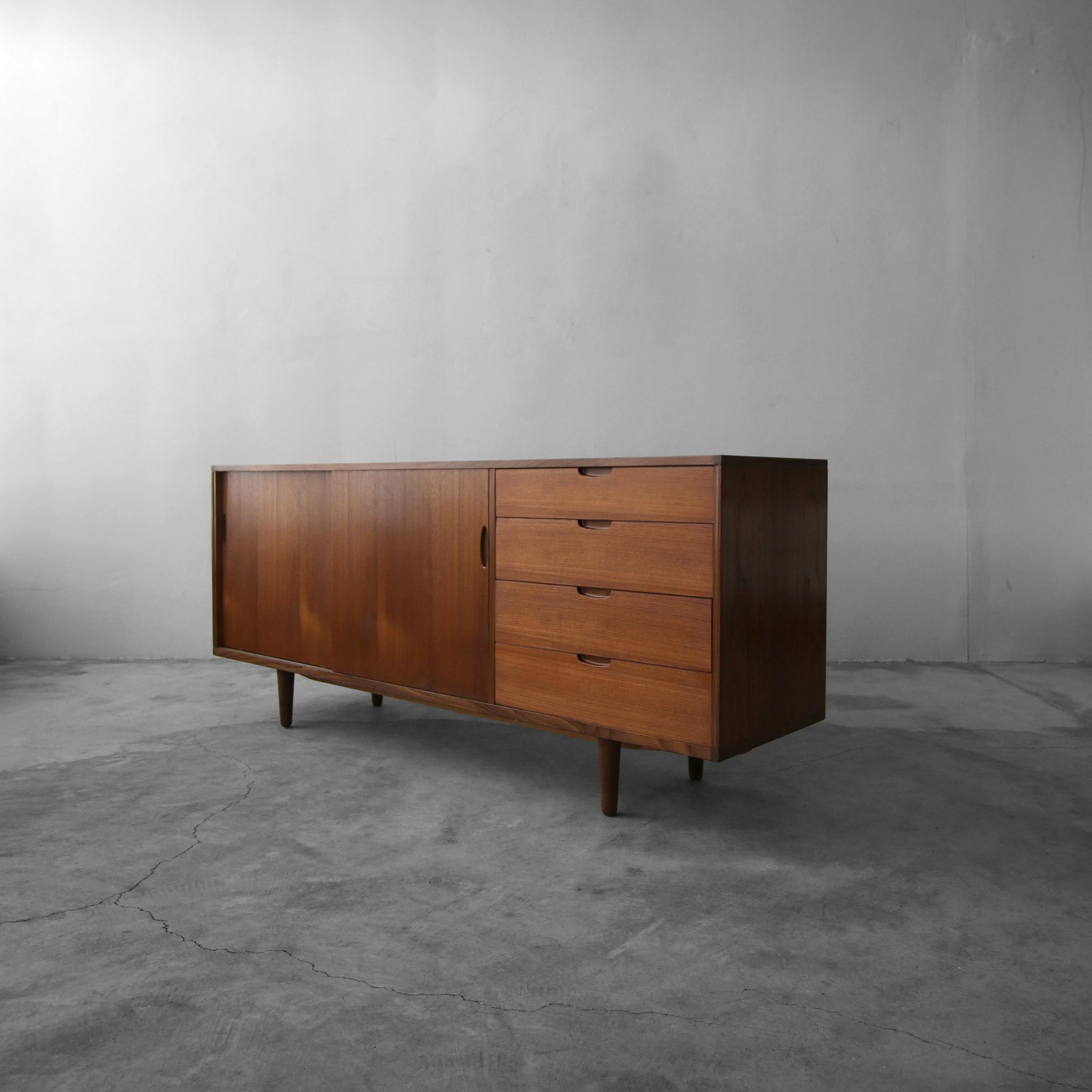 Simply perfect Danish teak credenza by IB Kofod Larsen for Clausen and Sons. The simplicity and clean lines make this beauty a Classic. A little bit shorter in length than a lot of Danish credenzas at 6 foot, this may be the perfect piece you've